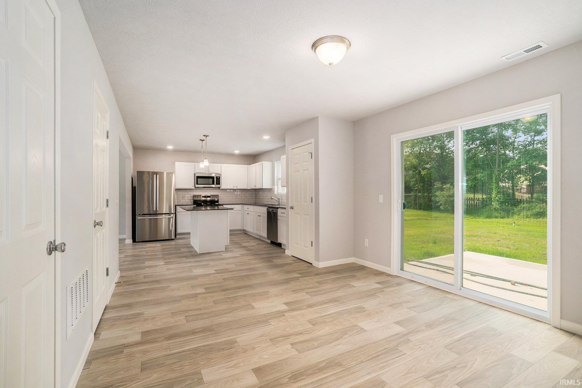 The dining nook can accommodate a large table and has direct access to the back yard.