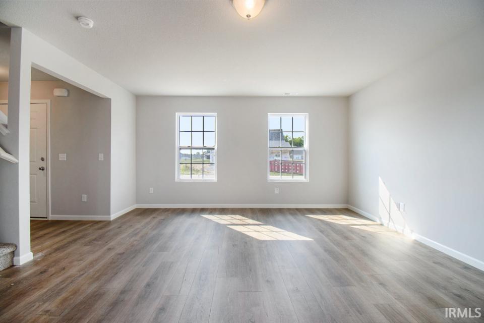 The large great room has an abundance of natural lighting and flows into a designer kitchen & nook.  Flooring is consistent throughout first floor.
