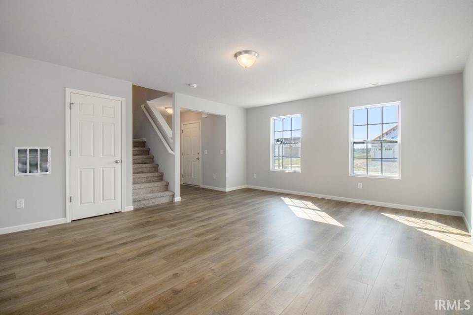 The large great room has an abundance of natural lighting and flows into a designer kitchen & nook.  Flooring is consistent throughout first floor.