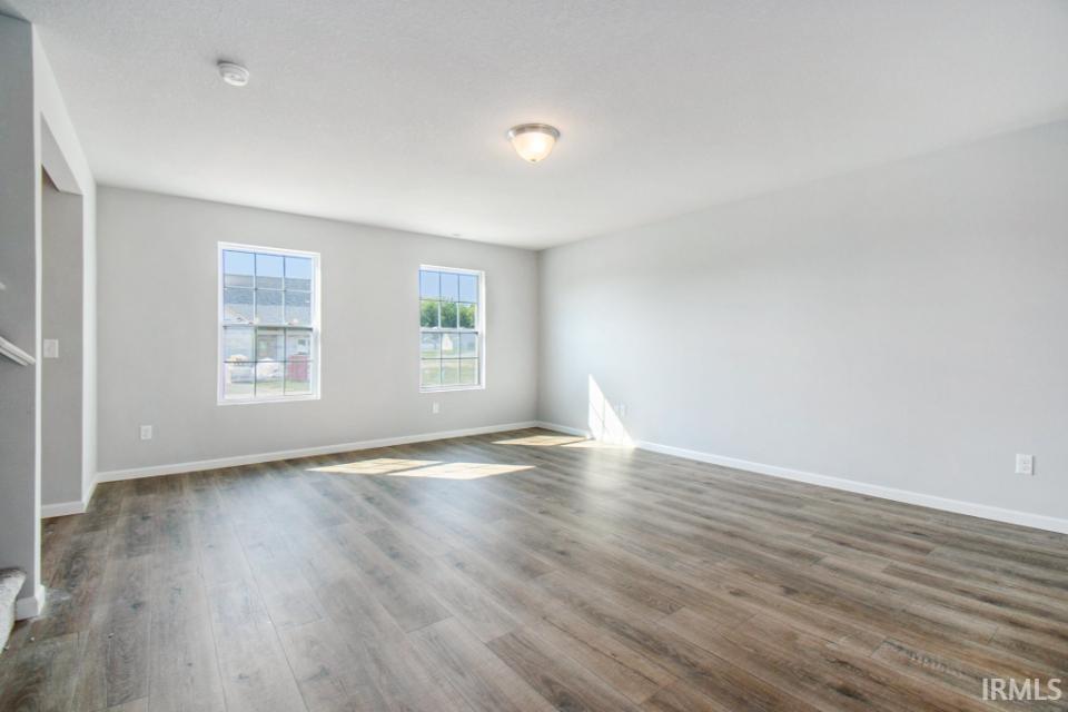 The large great room has an abundance of natural lighting and flows into a designer kitchen & nook.  Flooring is consistent throughout first floor.