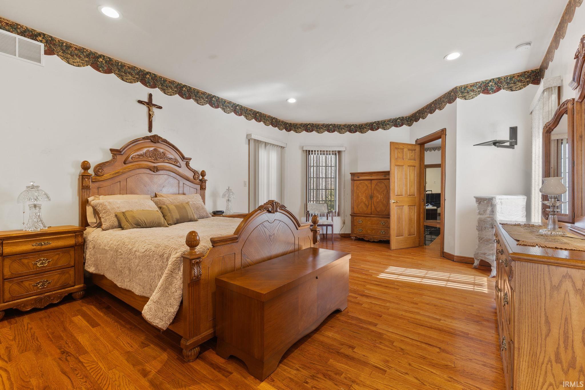 Main floor primary suite with full bath featuring a walk in closet, jetted tub, and separate shower.