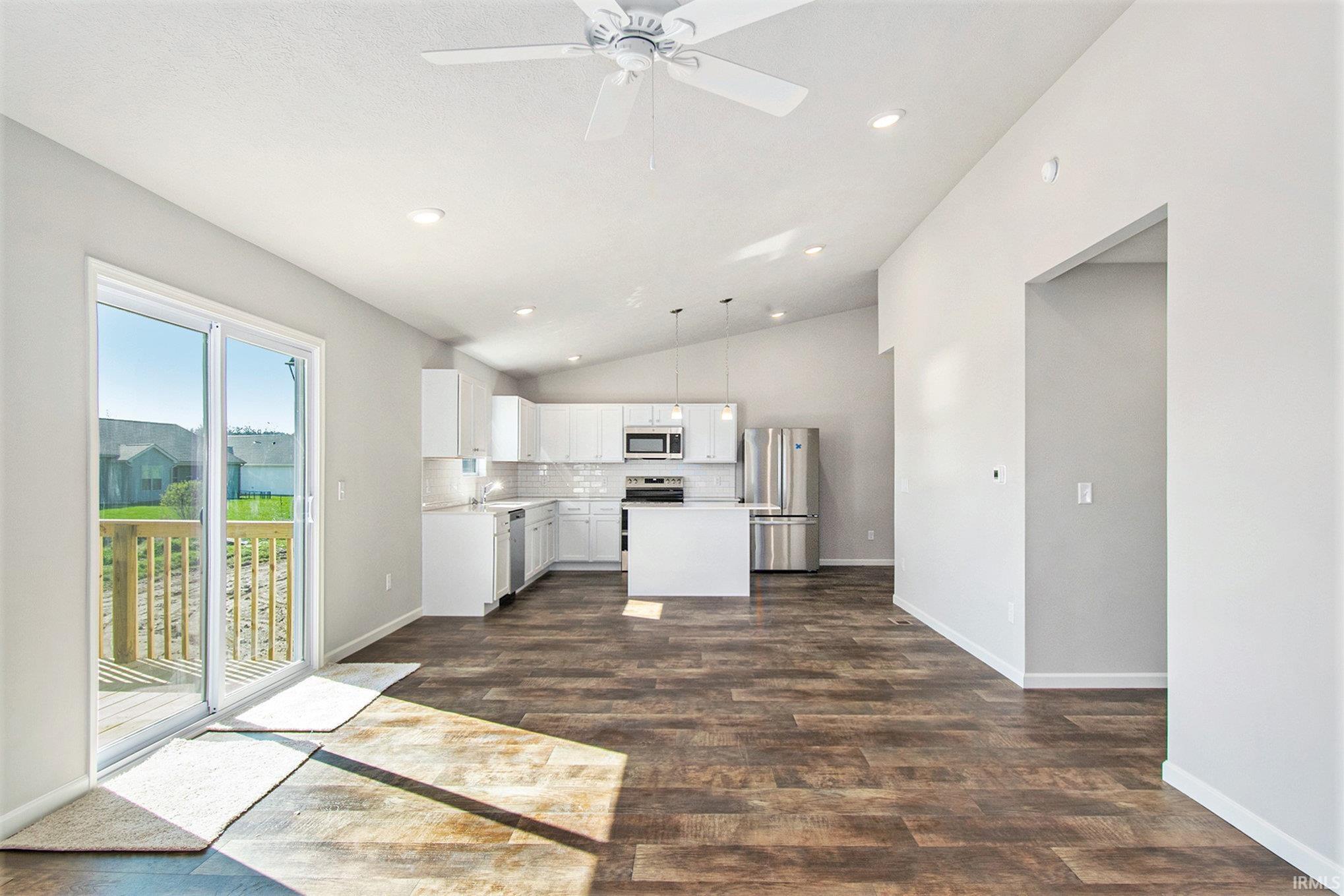 The kitchen flows into the great room – both featuring vaulted ceilings & recessed lighting.  The great room offers sliding door access to a large 10x10 deck.  Flooring is consistent throughout the great room and kitchen providing a seamless transition.