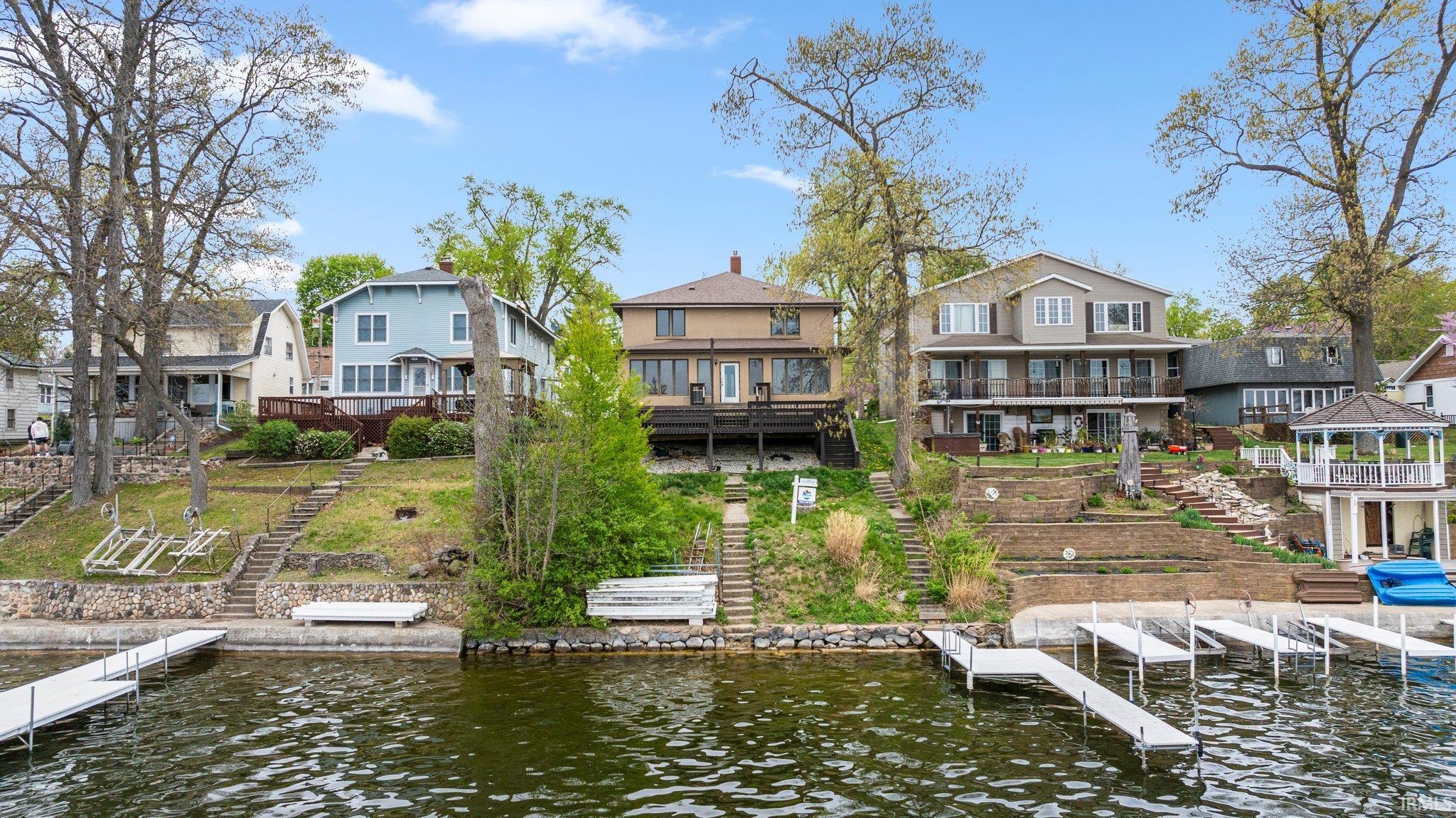 6 bedroom lakefront retreat on beautiful Webster Lake. Located in desirable Epworth Forest, this beautiful property offers 50 ft of lake frontage and nearly 3,000 square feet. The raised view looks out on middle of the lake — a hard to come by view. Designed with lake life in mind— the 23x33 living area is truly the heart of the home. Perfect for large gatherings, entertaining, or year round living. Not to mention the huge 3 seasons room that walks out to the multi level deck overlooking spectacular views of Webster Lake. The main level also offers a nice kitchen space and full bath/ laundry combo. Upstairs can be accessed from 2 different staircases and offers 6 bedrooms including spacious bunk rooms, along with 1.5 baths. Additional features of the home include: hardwood floor, statement stone fireplace, and 5 year old roof. Many of the furnishings are negotiable. Enjoy all that Webster Lake has to offer from swimming, skiing, boating and fishing. Whether you are looking for a summer home large enough for all your guests or a year round home, this home is truly a home that can be cherished for generations to come!
