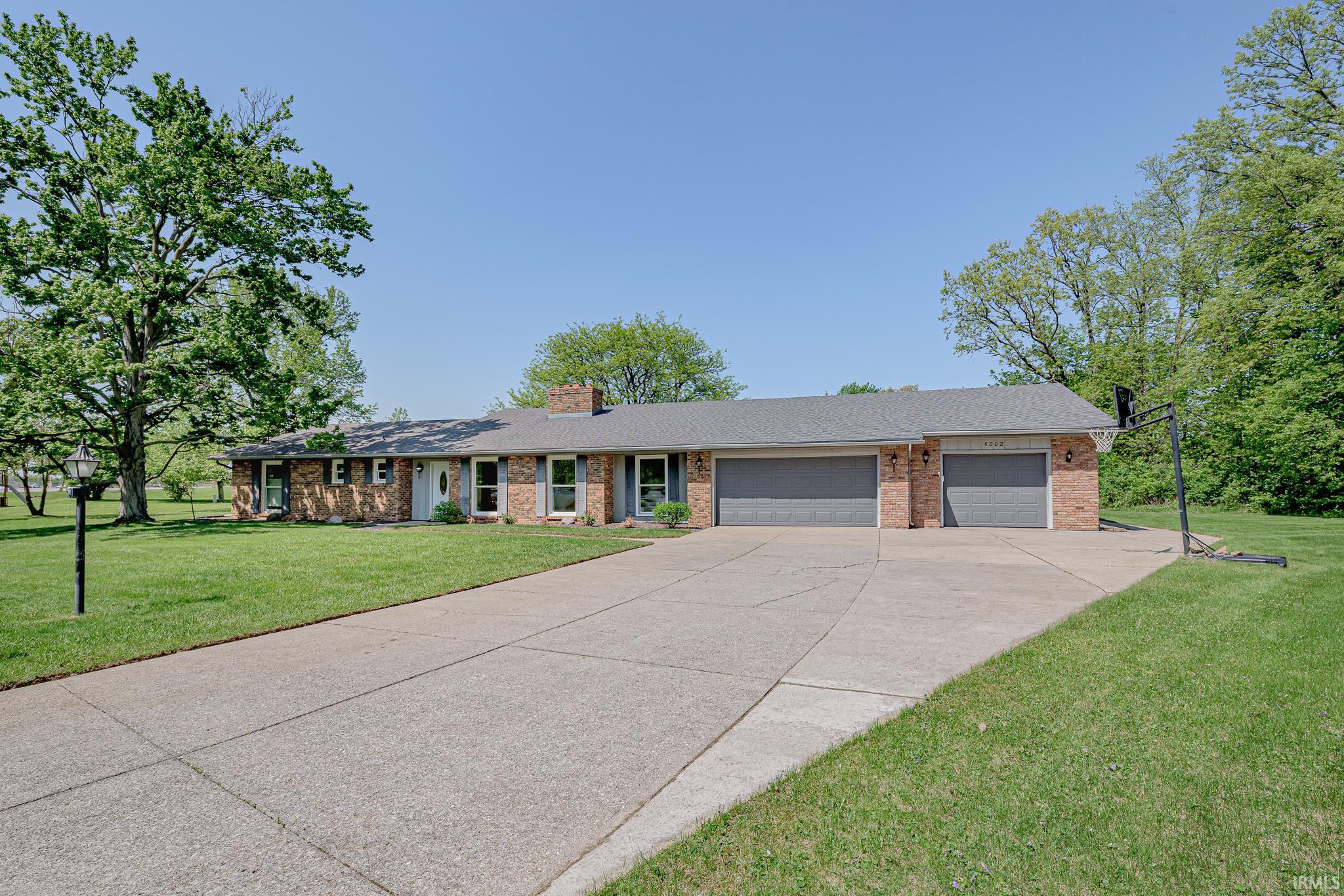 Beautiful sprawling ranch in Kekionga Shores! If you love outdoor space, this home is situated on a 1/2 an acre lot backing up to the Jorgensen YMCA Indian Trails Park — giving you walking trails in your own backyard! Along with that, Kekionga Shores has its own private 26 acre lake, giving you access to boating, water sports, swimming, and fishing. Inside the home is just as impressive with over 2800 square feet. Home welcomes you with a huge living room with cathedral ceilings and gas fireplace, 4 bedrooms, a den, and a second living area. Whether you want a craft room, homeschool room, or bonus living room, there is the perfect space for it! Additional features to note include: built in cabinetry in the dining room, security system, low maintenance landscape rock, large walk in closets in two of the bedrooms, ample storage space, and a 3 car garage. Updates to the home include: new windows (2015), new furnace/ac/ductwork (2018), new water heater (2019), new sewer pipe (2020), and new carpet (2023). This home has so much to offer and located in amazing proximity to Homestead High School, YMCA, Lutheran Hospital, stores, and restaurants; be sure to check it out!