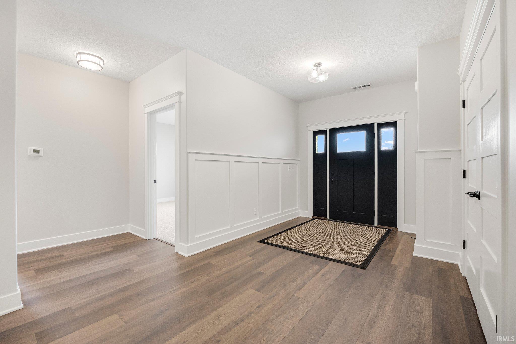 Large Open Foyer with Board and Batten Trim. 5 panel solid wood doors throughout the home. Lighting hardwired in every closet. Entry Door is Craftsman style with plenty of light! 9 Ft Ceilings & Rounded corners are a few of the additional amenities!