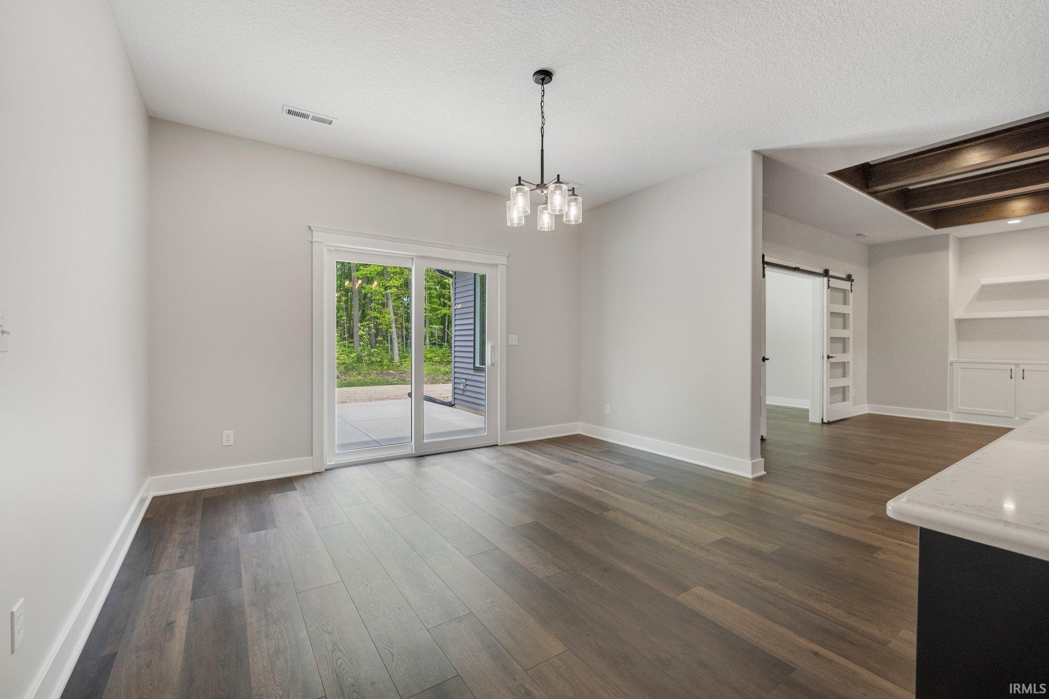 Entertain your Guests w/room for your buffet or curio in this spacious dining area! Views of the wooded backdrop and patio as well!  All light and bright & ove in ready!