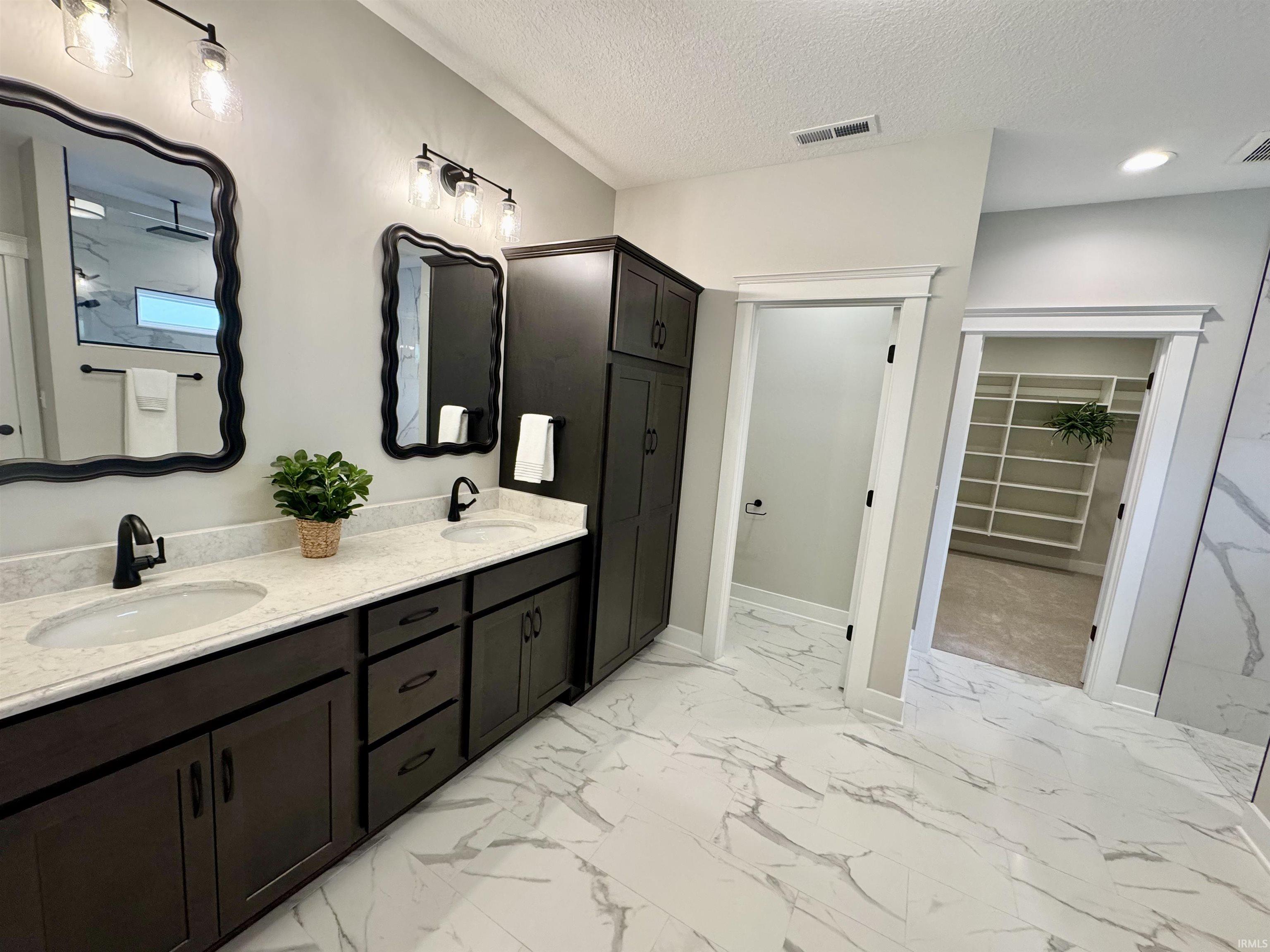 Open Light and bright master en-suite w/custom tile, walk-in shower, cabinetry, closet for storage. Very Spacious!