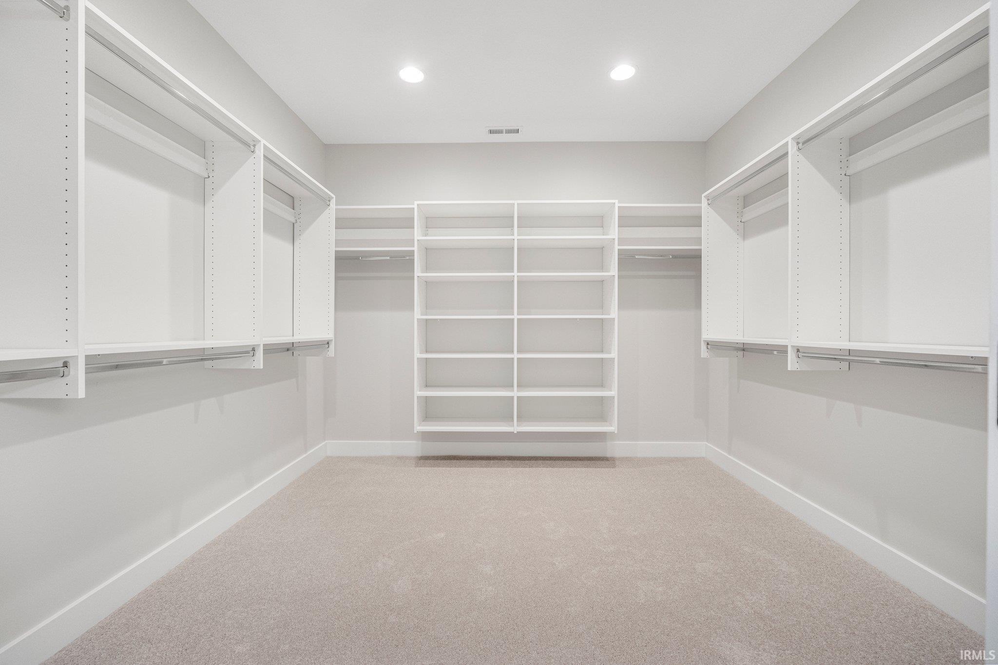 11x11 Walk-in master closet with closet concepts shelving, & room for your 4FT Island in the middle.