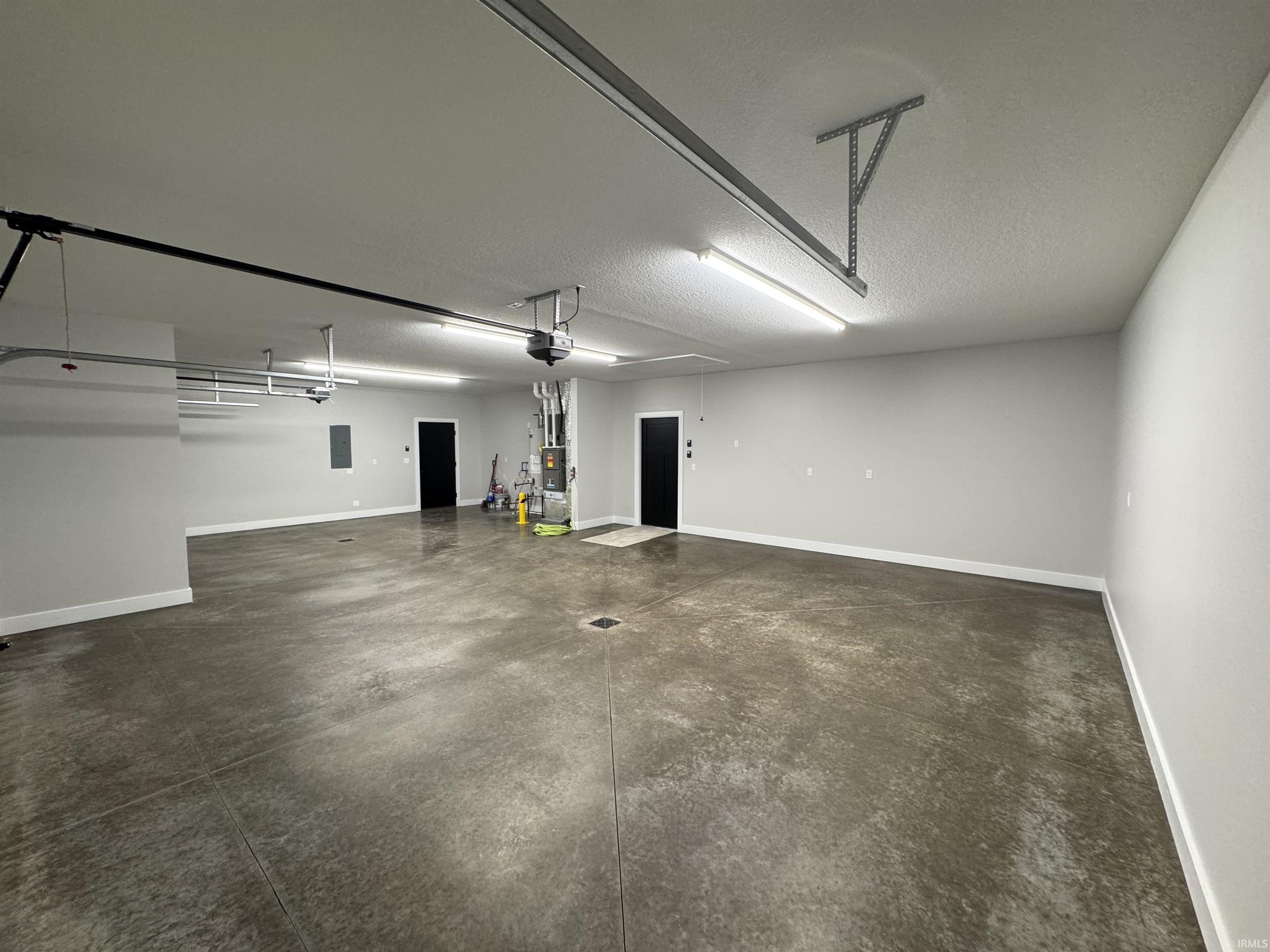 39x25 Fin & insulated garage. Floored attic above w/LED lighting. 2 belt driven garage door openers, 2 floor drains, room for your freezer, extra refrigerator.  Plumbed for R/O, & water softener.