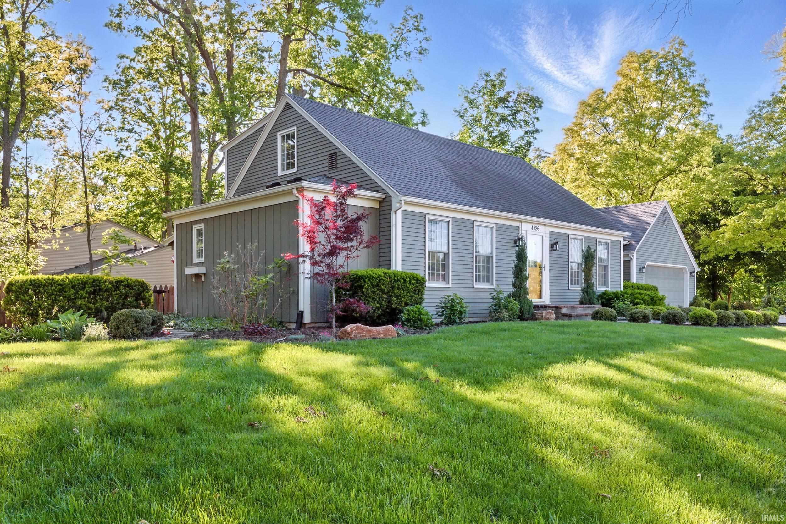 Updated landscaping and brick front porch will make you feel right at home!