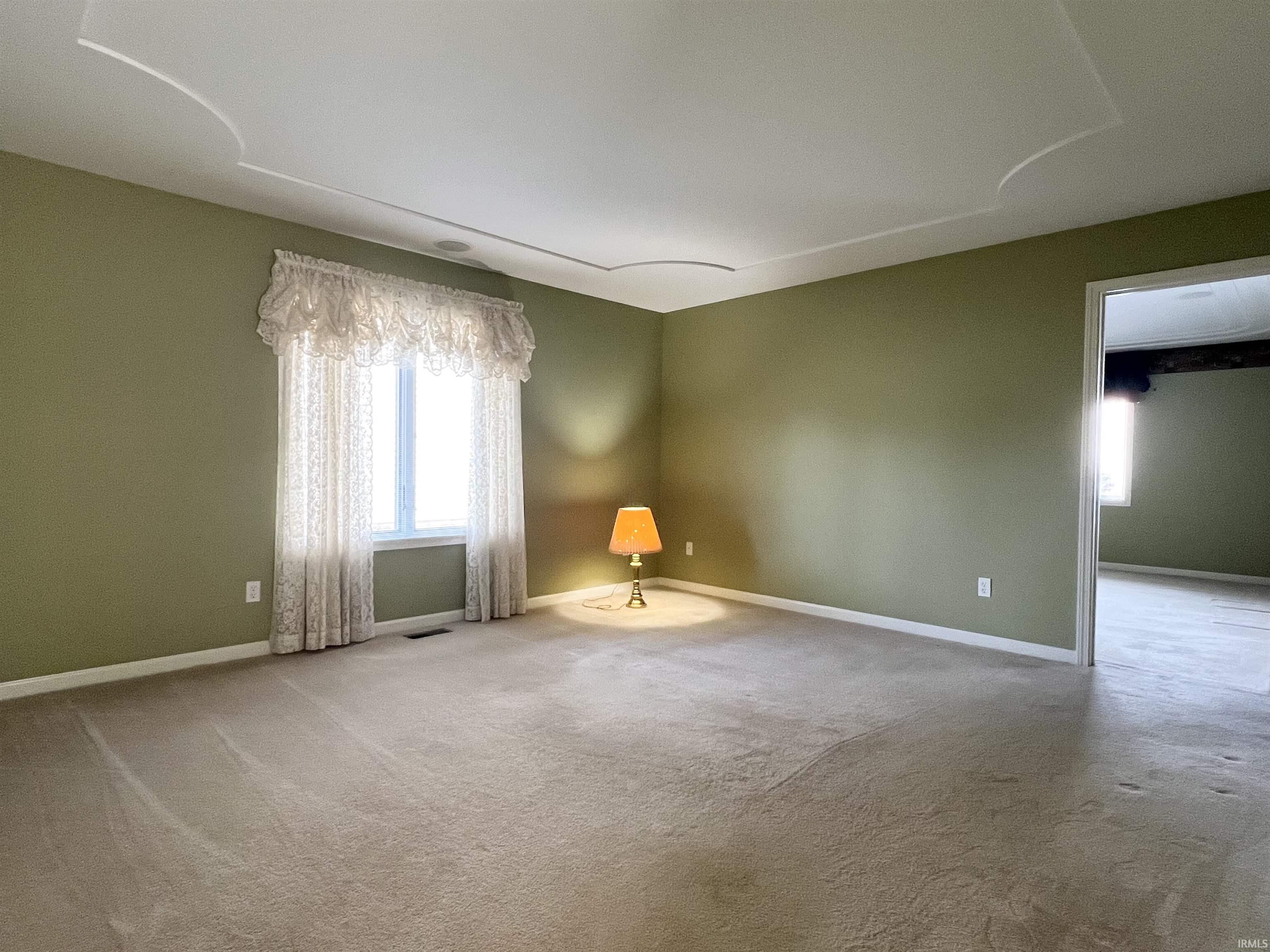 Spare room with carpet floors and baseboards