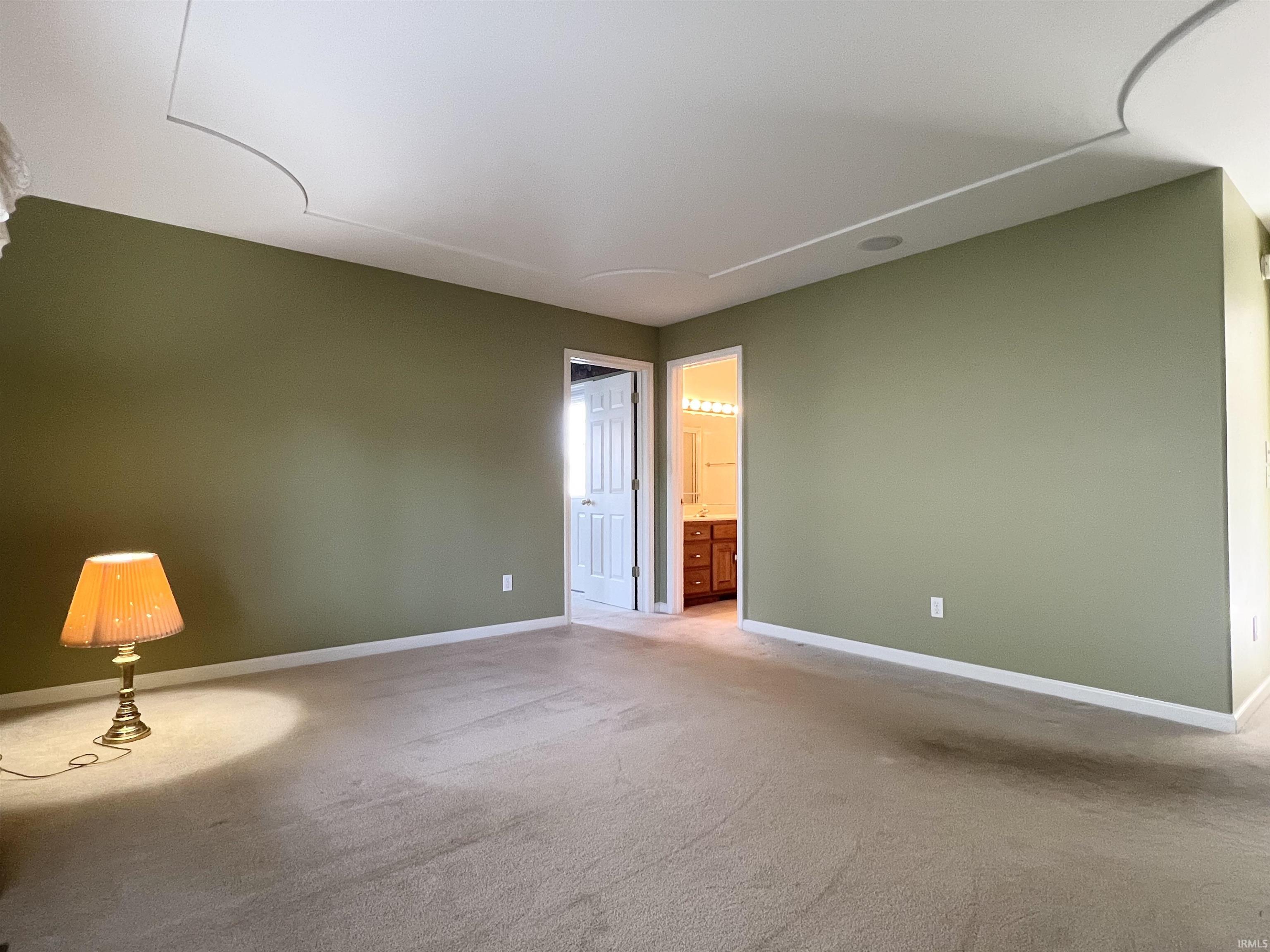 Unfurnished room featuring carpet floors and baseboards