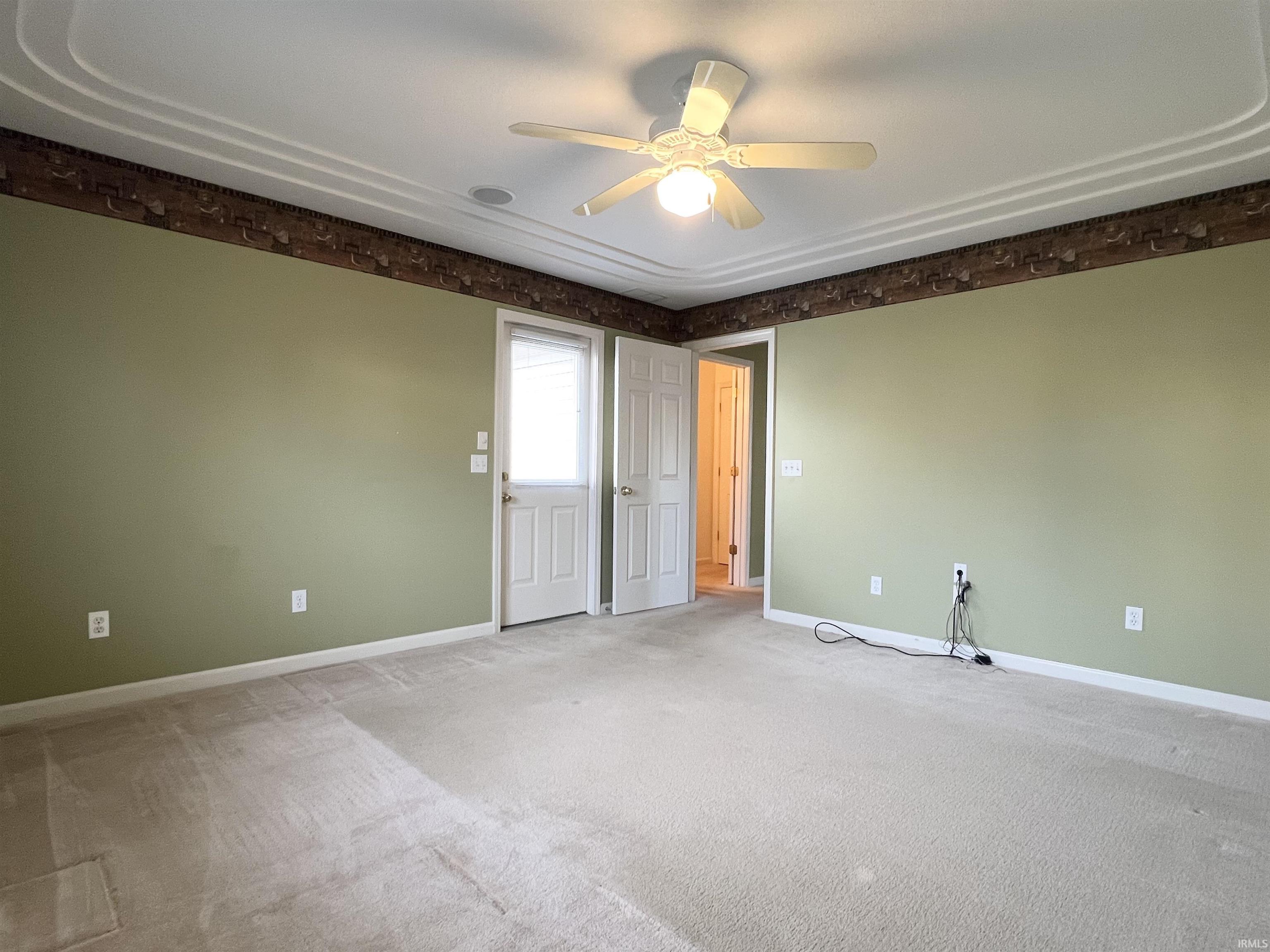 Unfurnished room with ceiling fan and carpet flooring