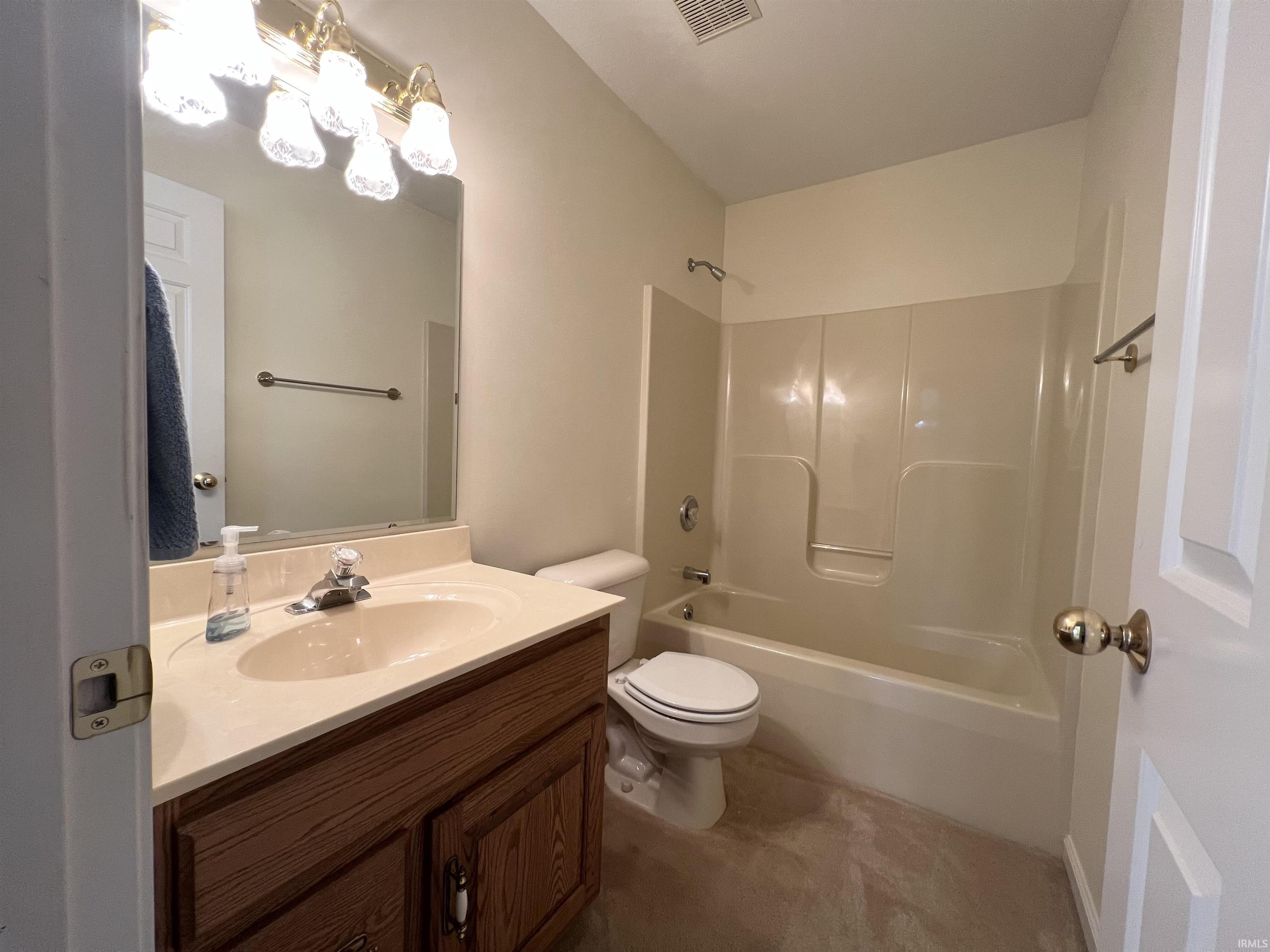 Full bathroom with vanity and washtub / shower combination