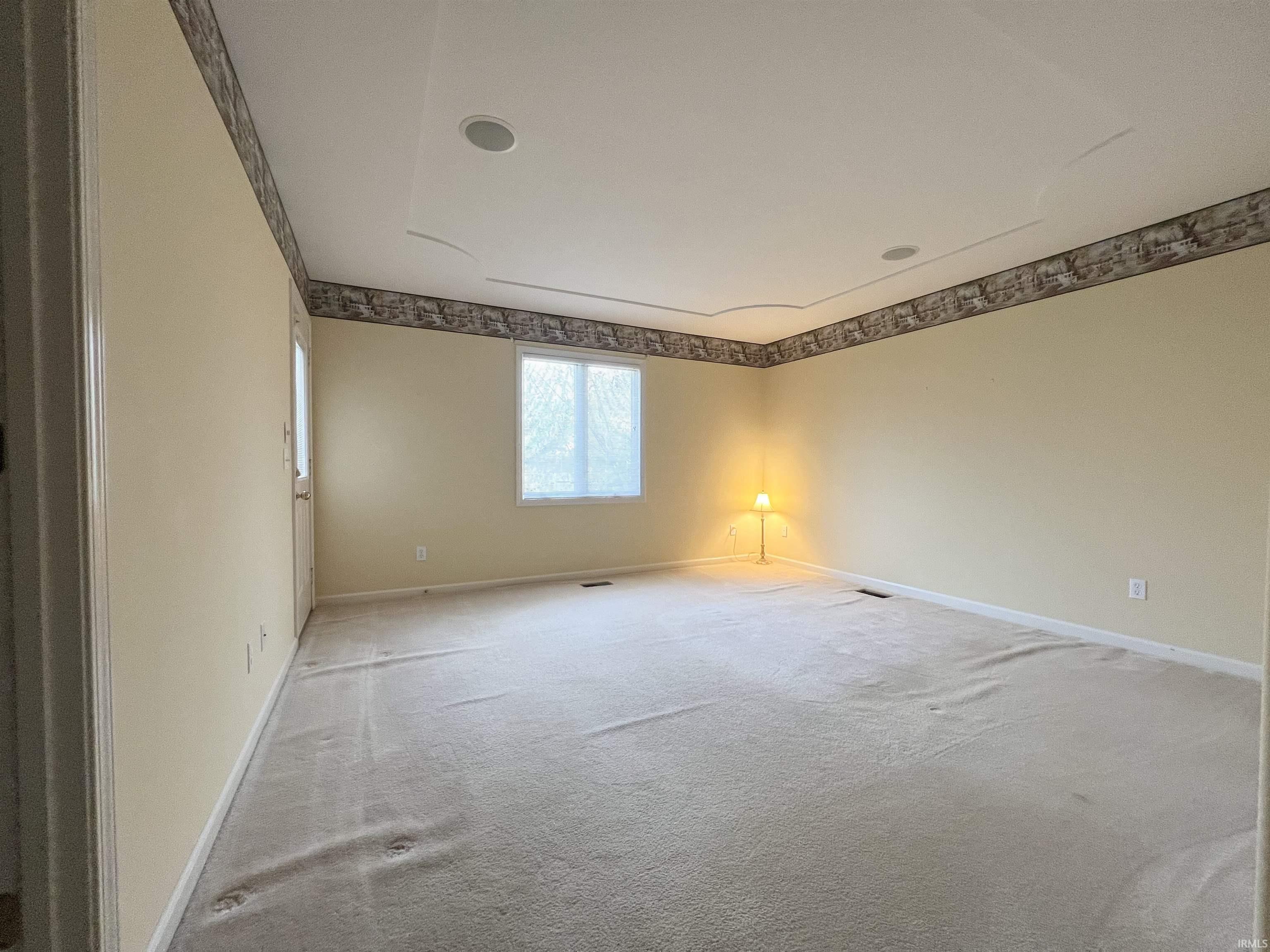 Empty room with carpet flooring and baseboards
