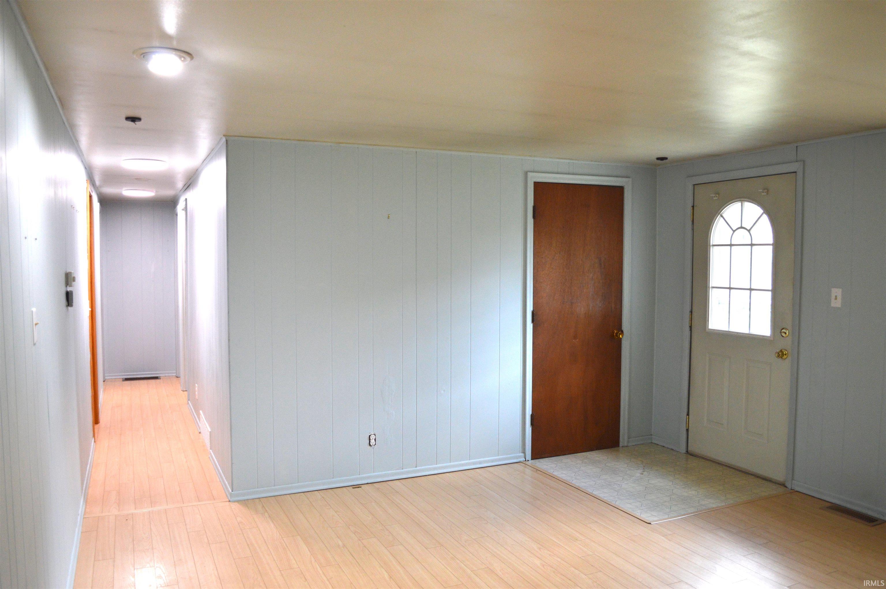 Living room looking down the main hallway leading to bathroom and bedrooms.