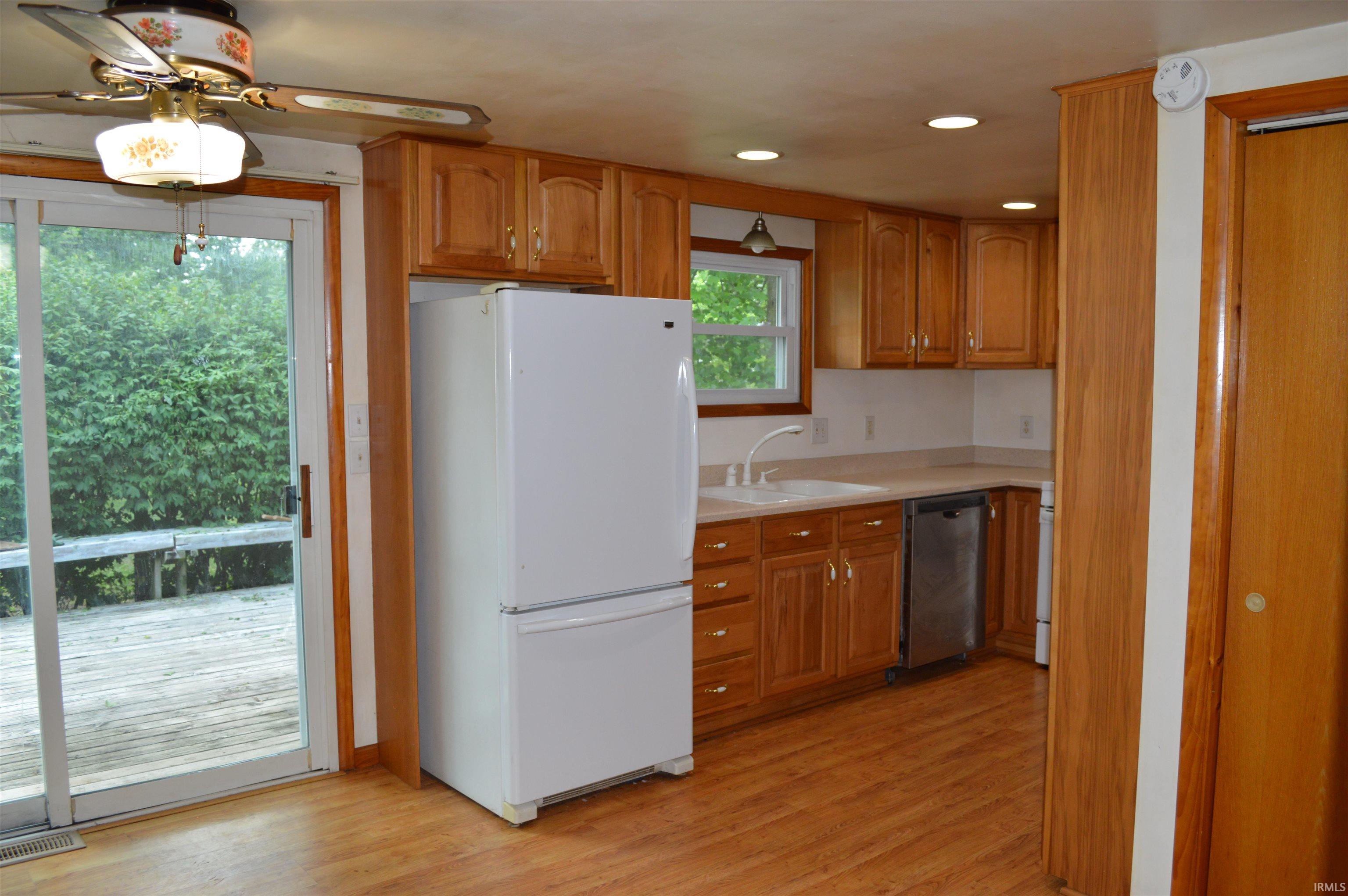 Dining area looking into kitchen and back deck area.