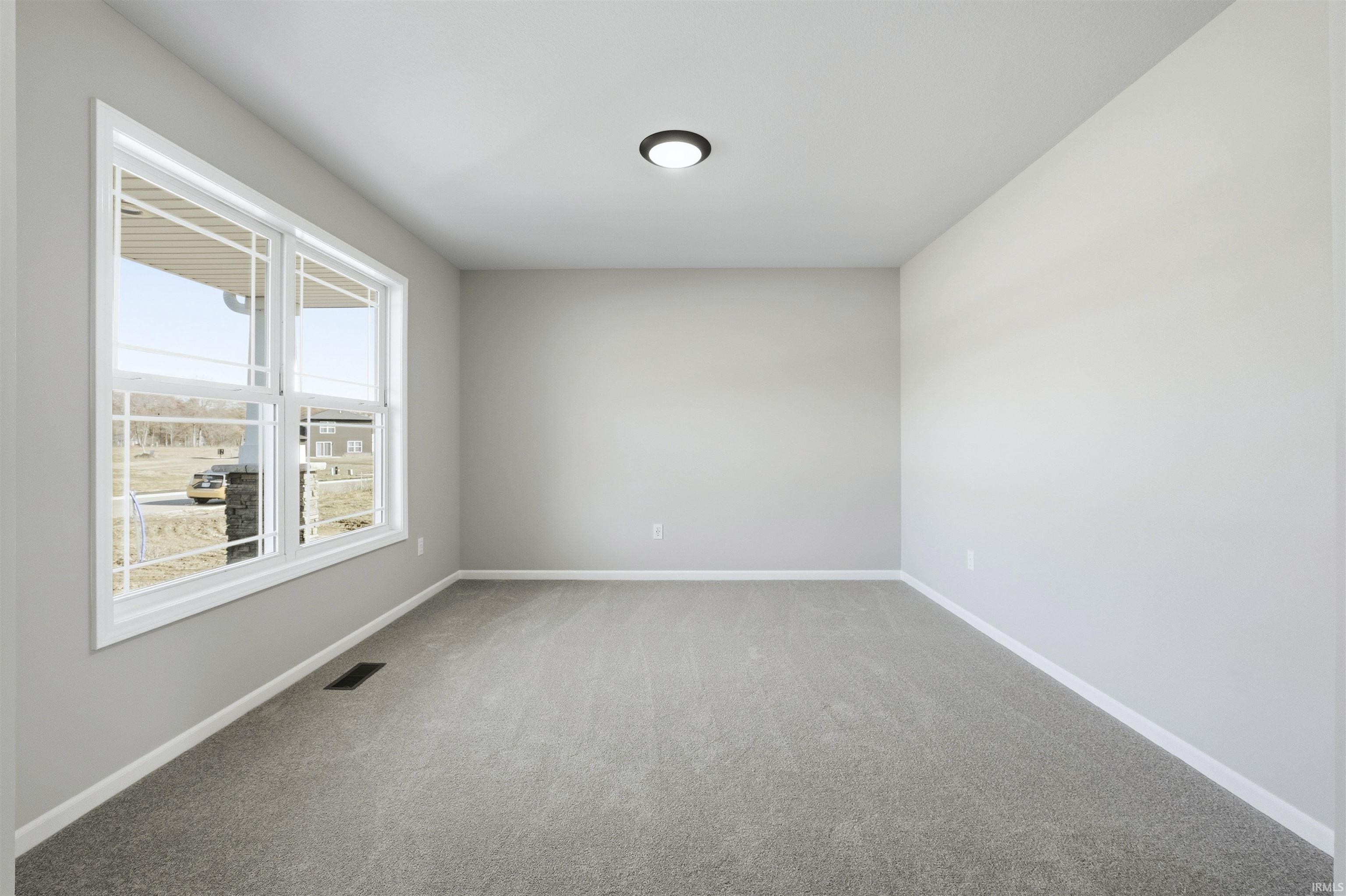 Carpeted empty room featuring baseboards