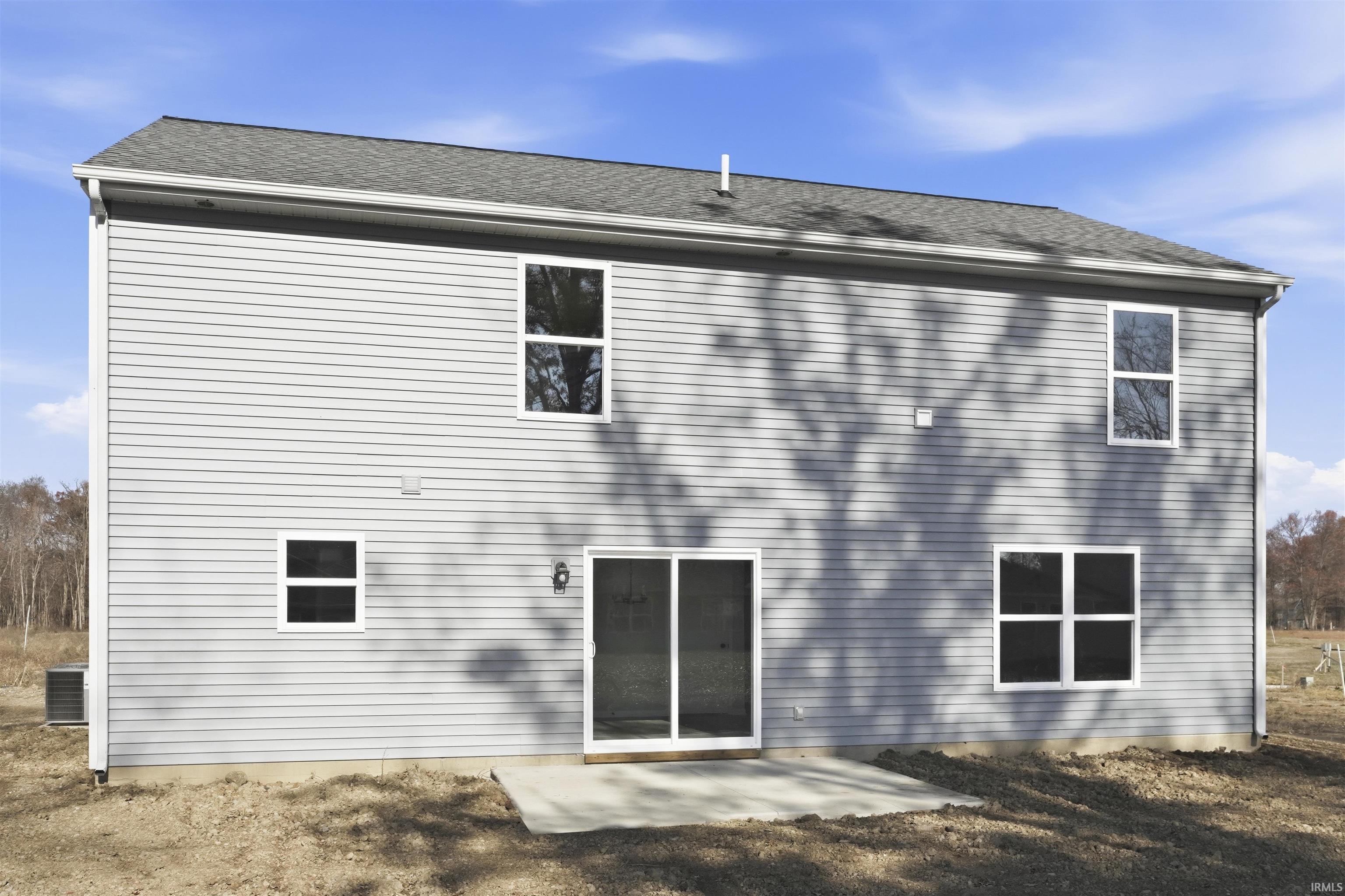 Back of property featuring a patio area and roof with shingles