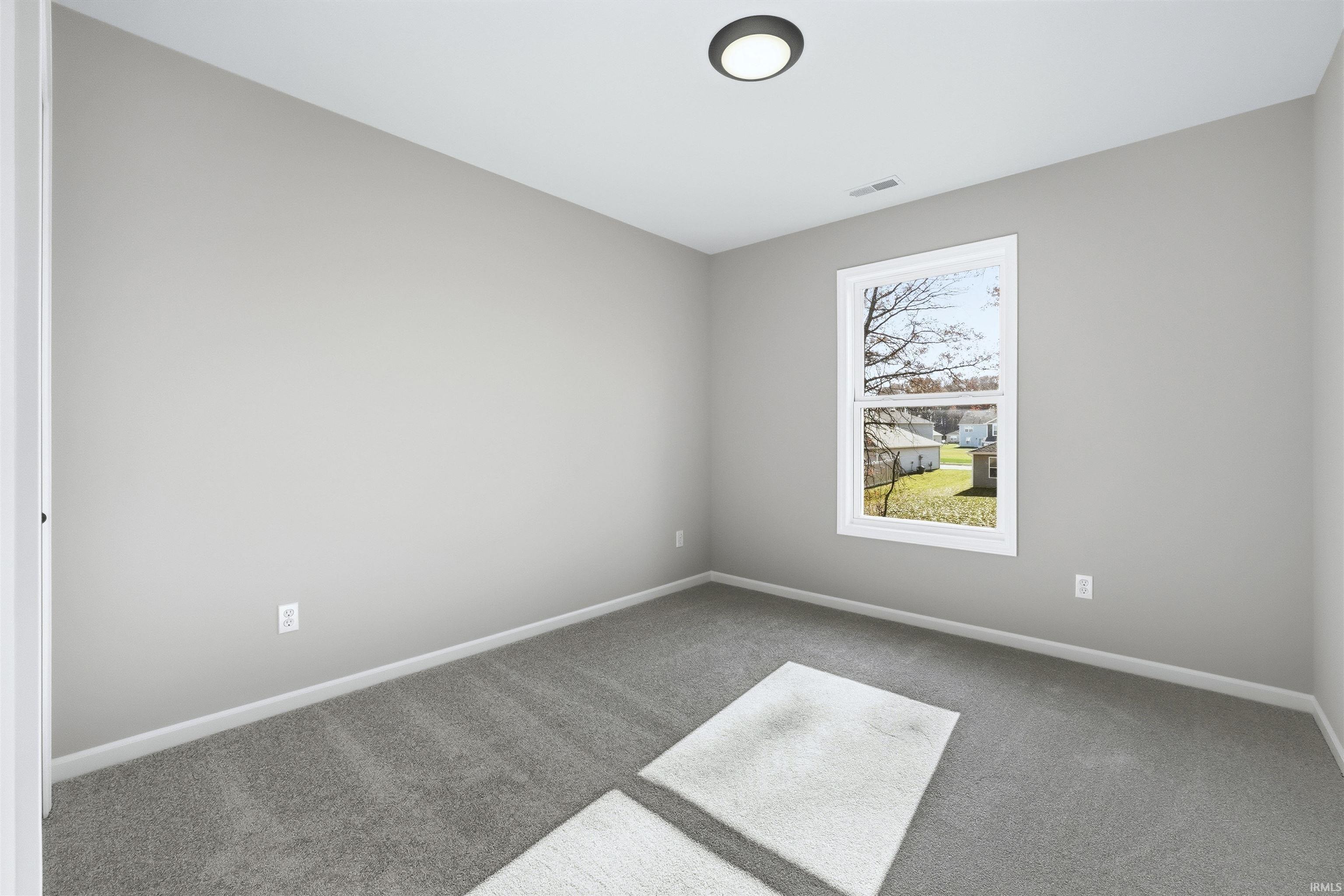Unfurnished room featuring carpet flooring