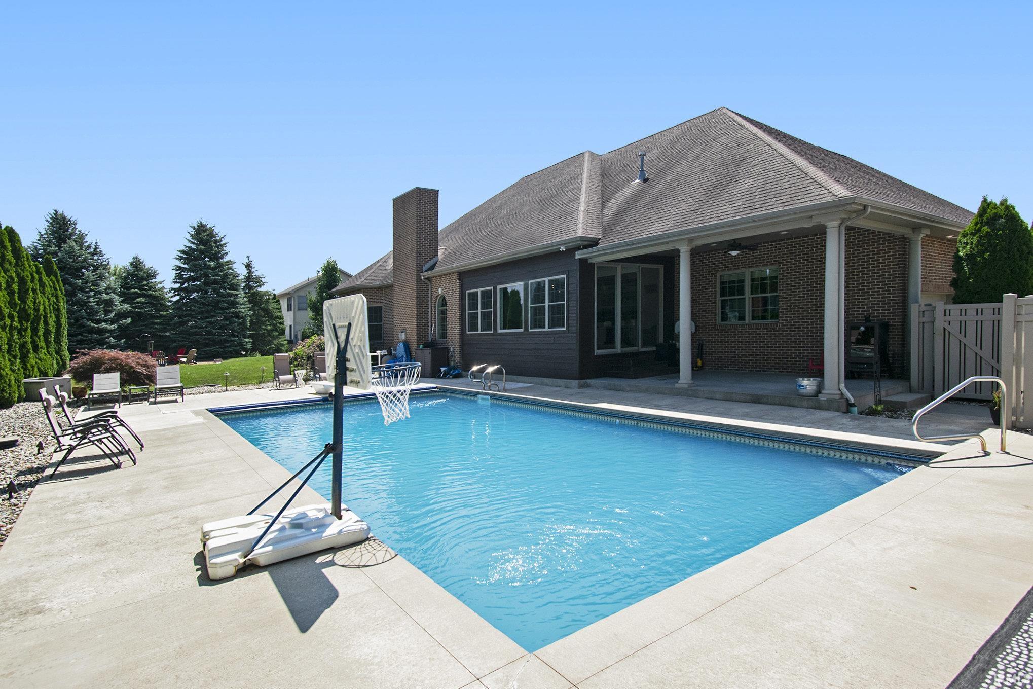 Private Backyard Oasis Featuring a Heated In-Ground Pool with Automatic Cover and Covered Patio