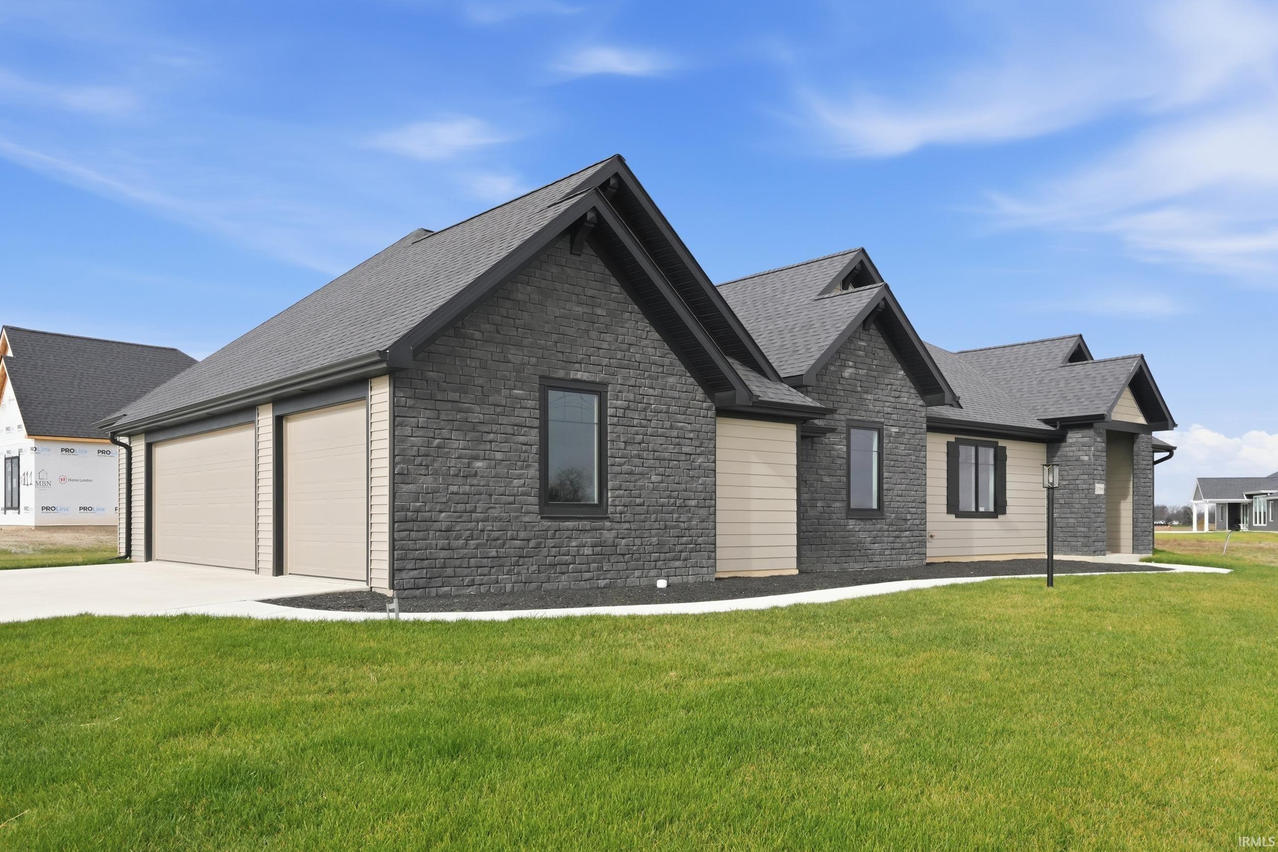Craftsman inspired home with a front yard, stone siding, roof with shingles, and concrete driveway
