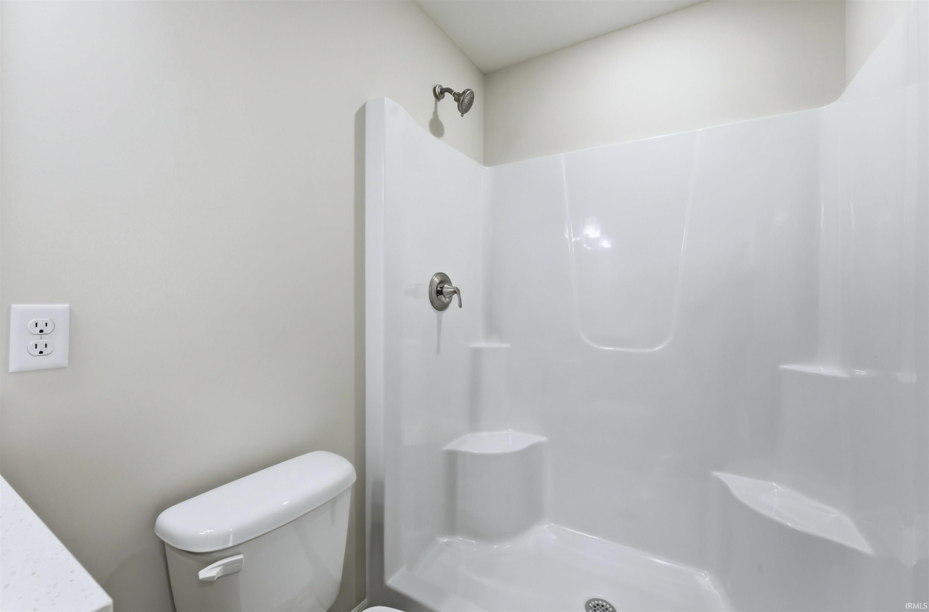 Bathroom with a shower stall and vanity