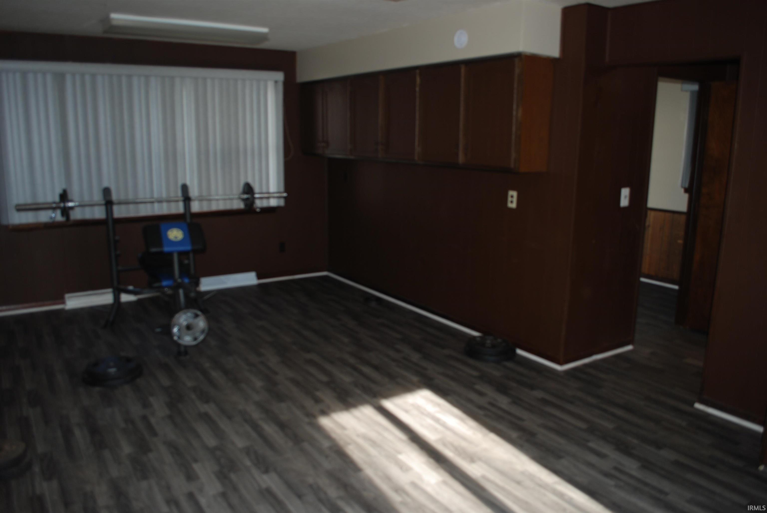 Kitchen with dark wood finished floors and baseboards