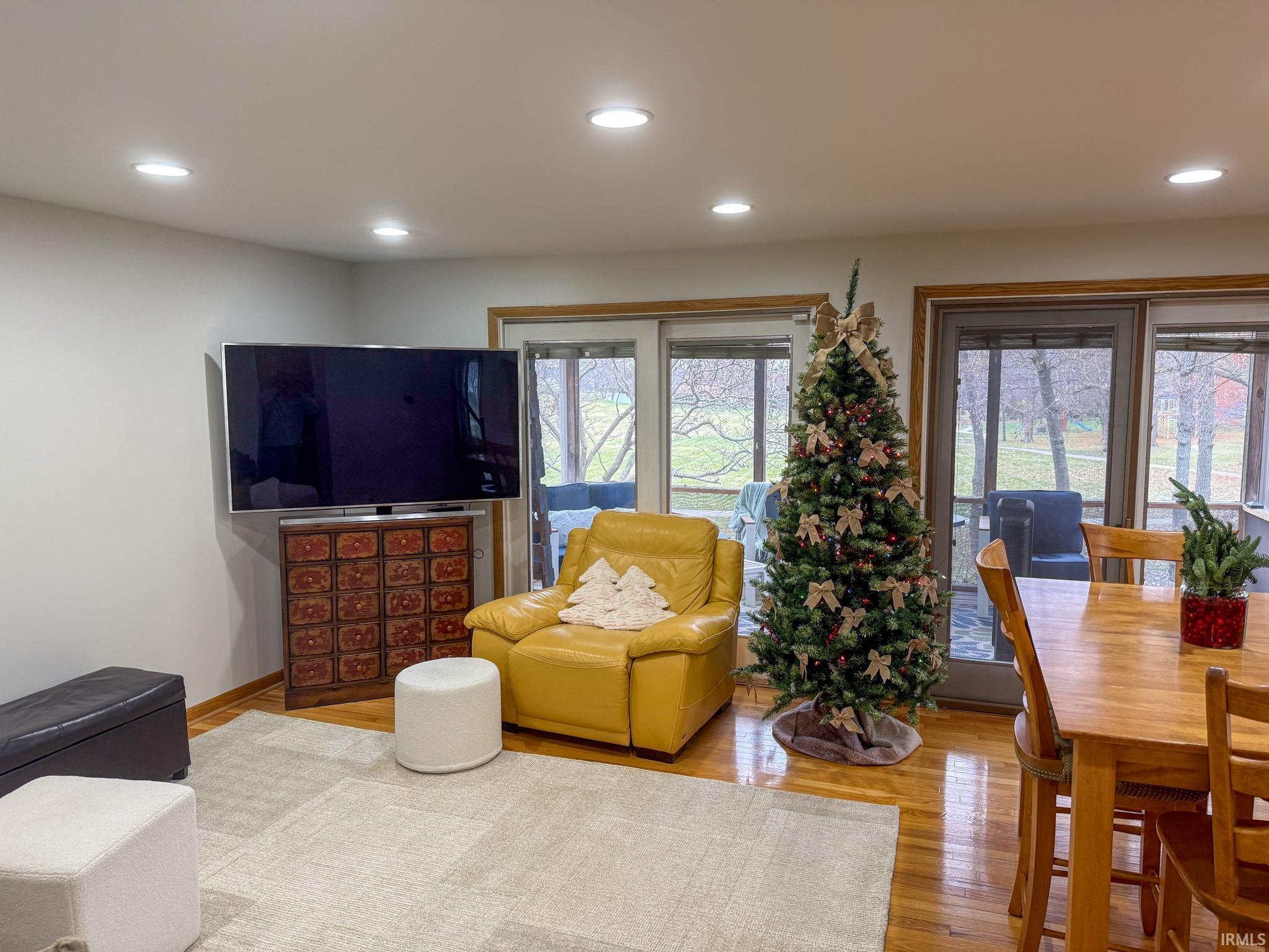 Living room featuring wood finished floors, plenty of natural light, and recessed lighting