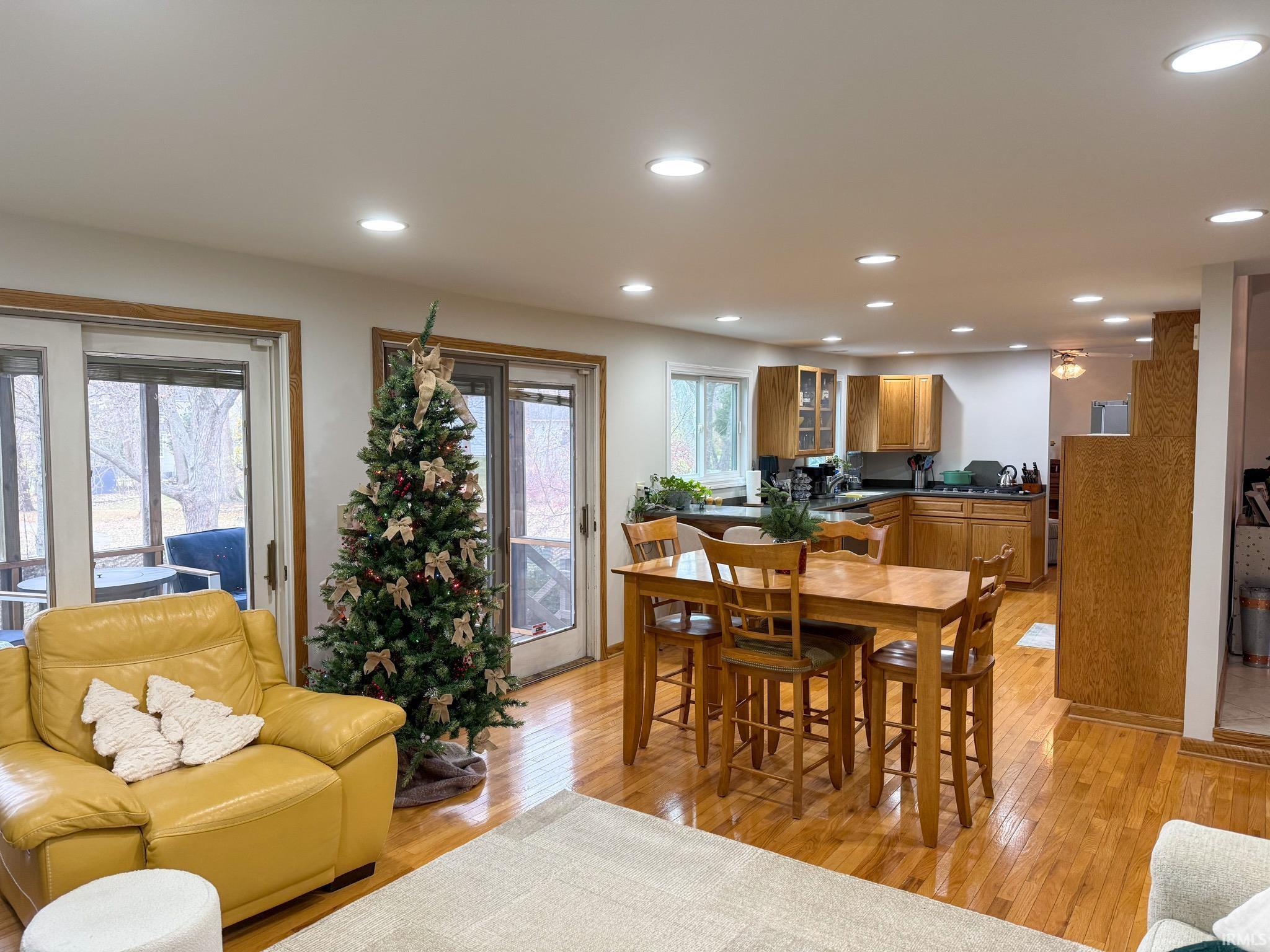 Dining area with light wood-style floors and recessed lighting