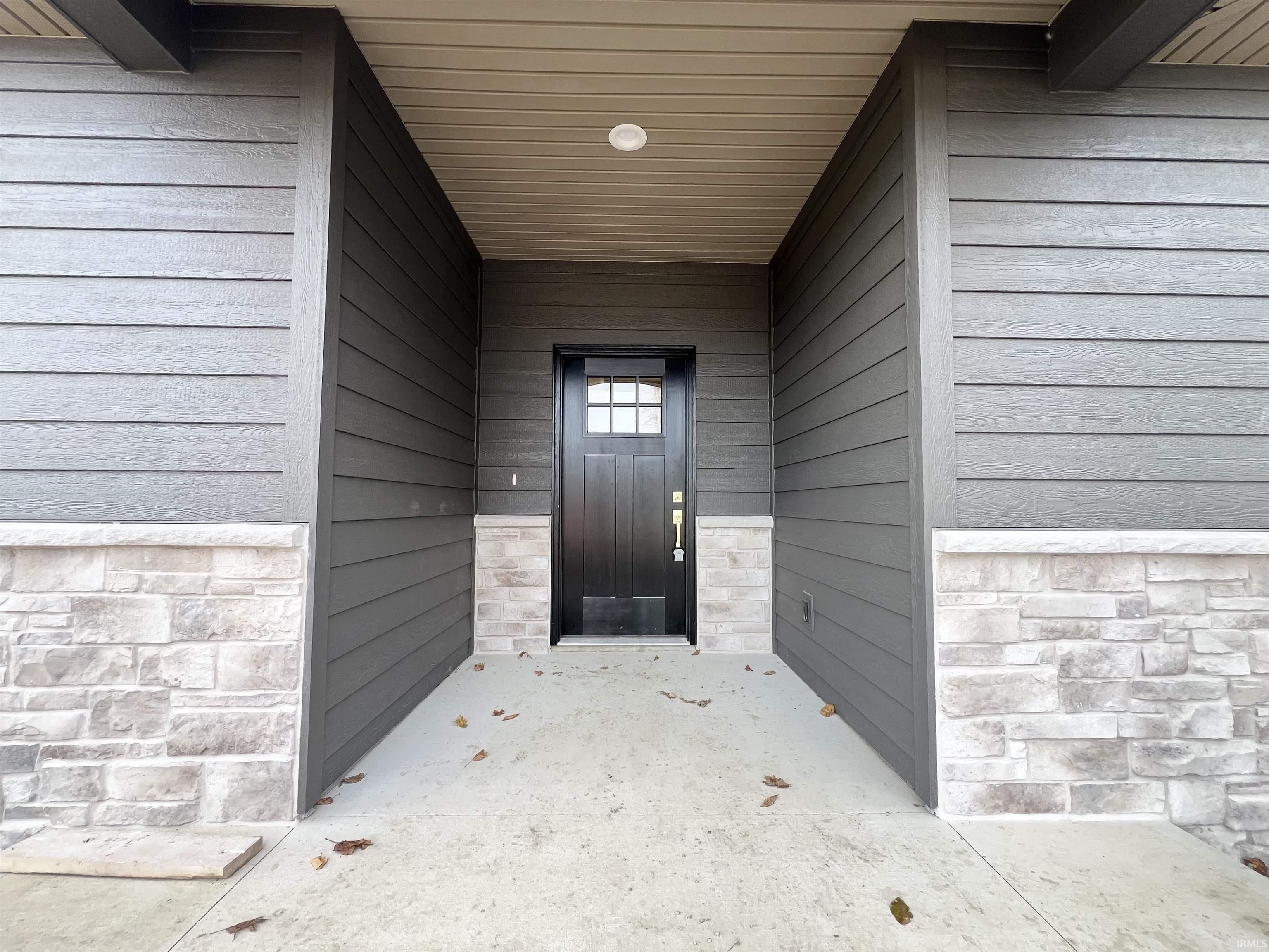 Entrance to property with stone siding