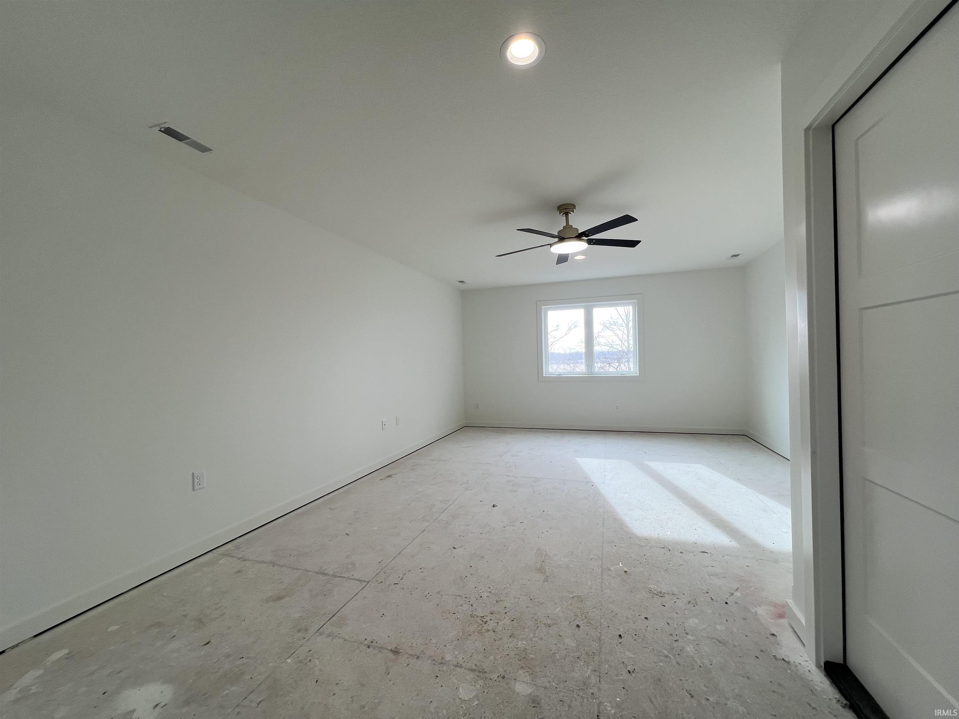Spare room with a ceiling fan and baseboards