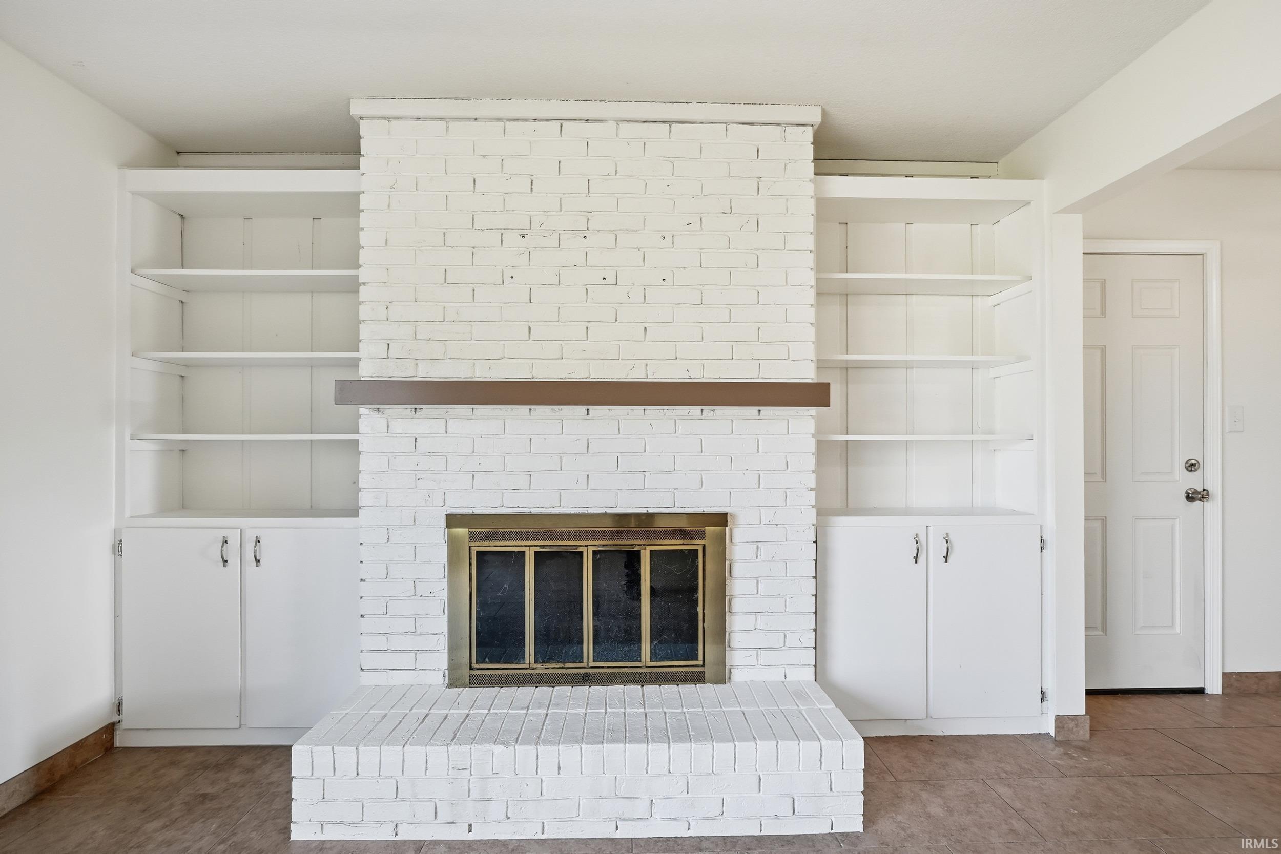 Detailed view of a brick fireplace and baseboards