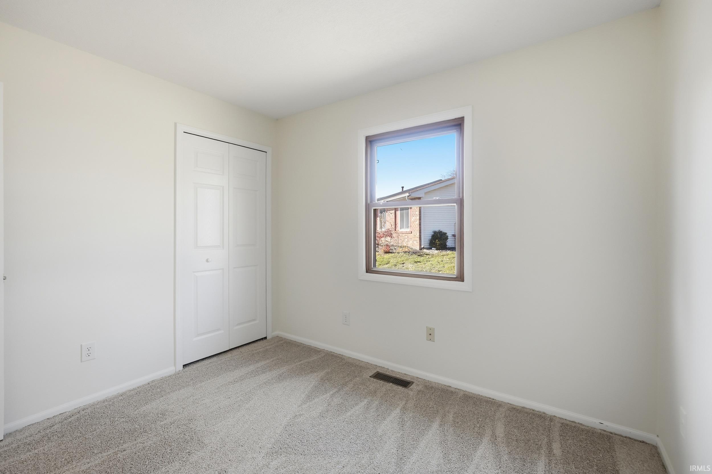 Unfurnished bedroom featuring carpet flooring and a closet