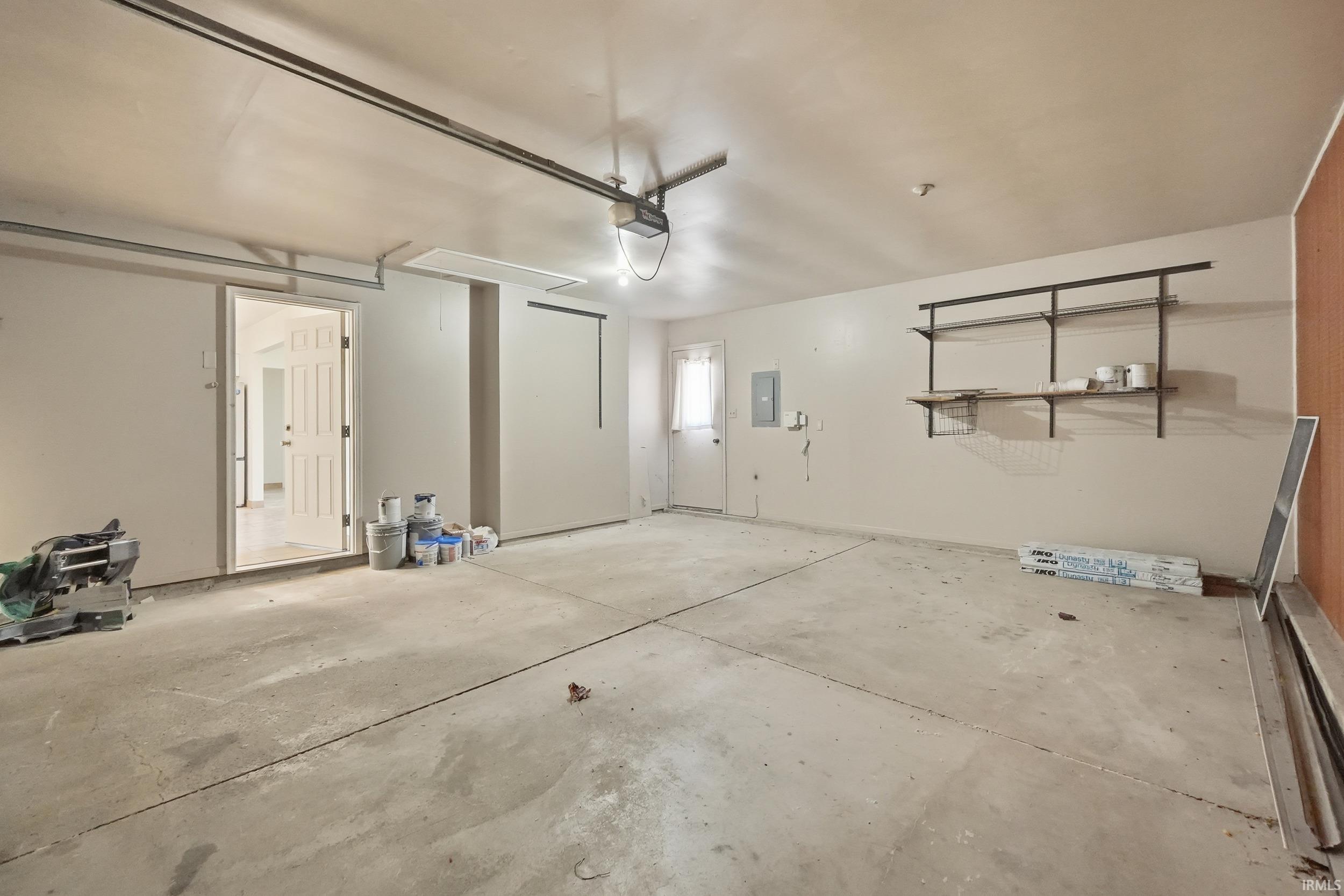 Garage with electric panel and a garage door opener