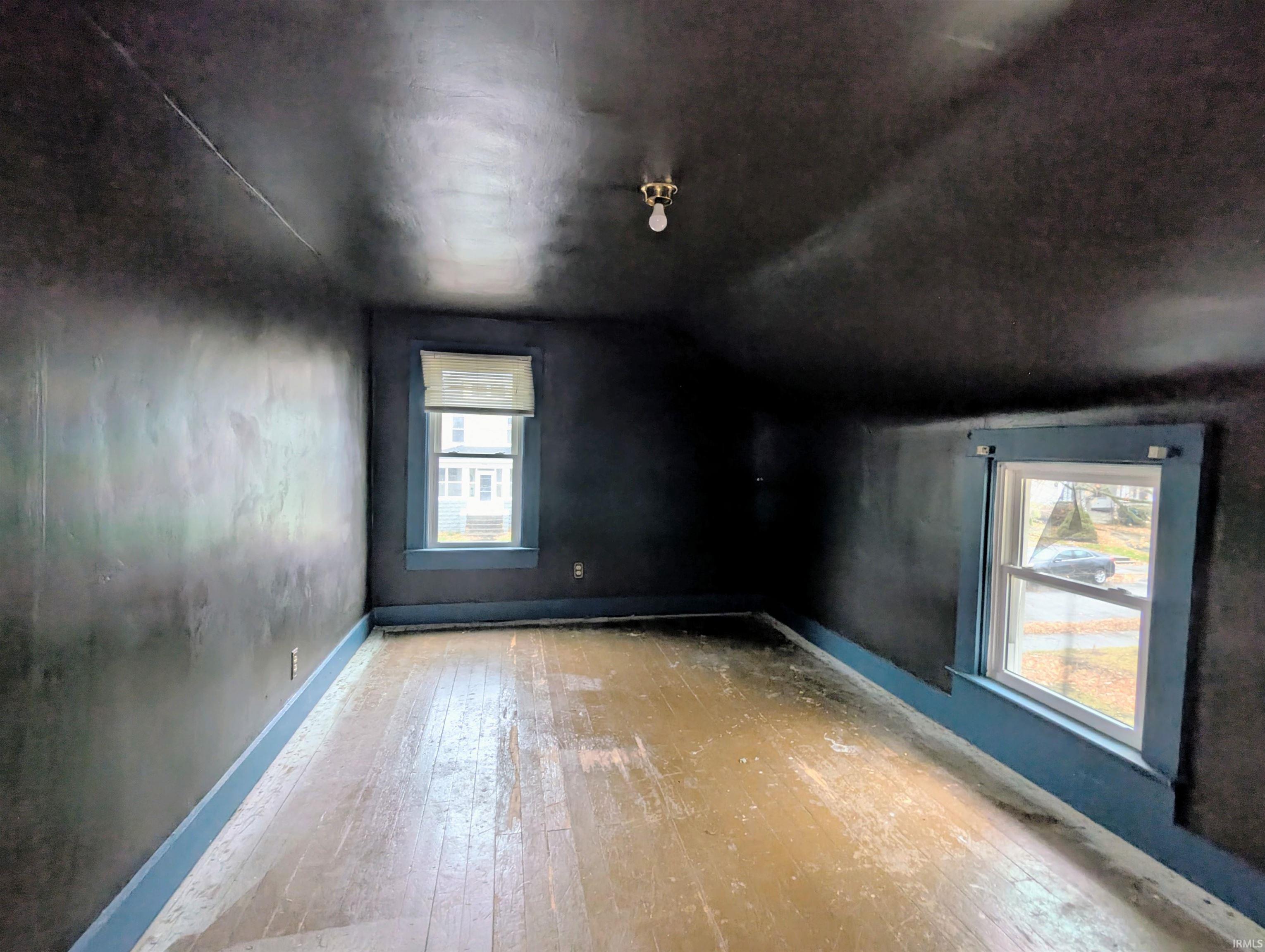 Bonus room with hardwood / wood-style flooring and vaulted ceiling