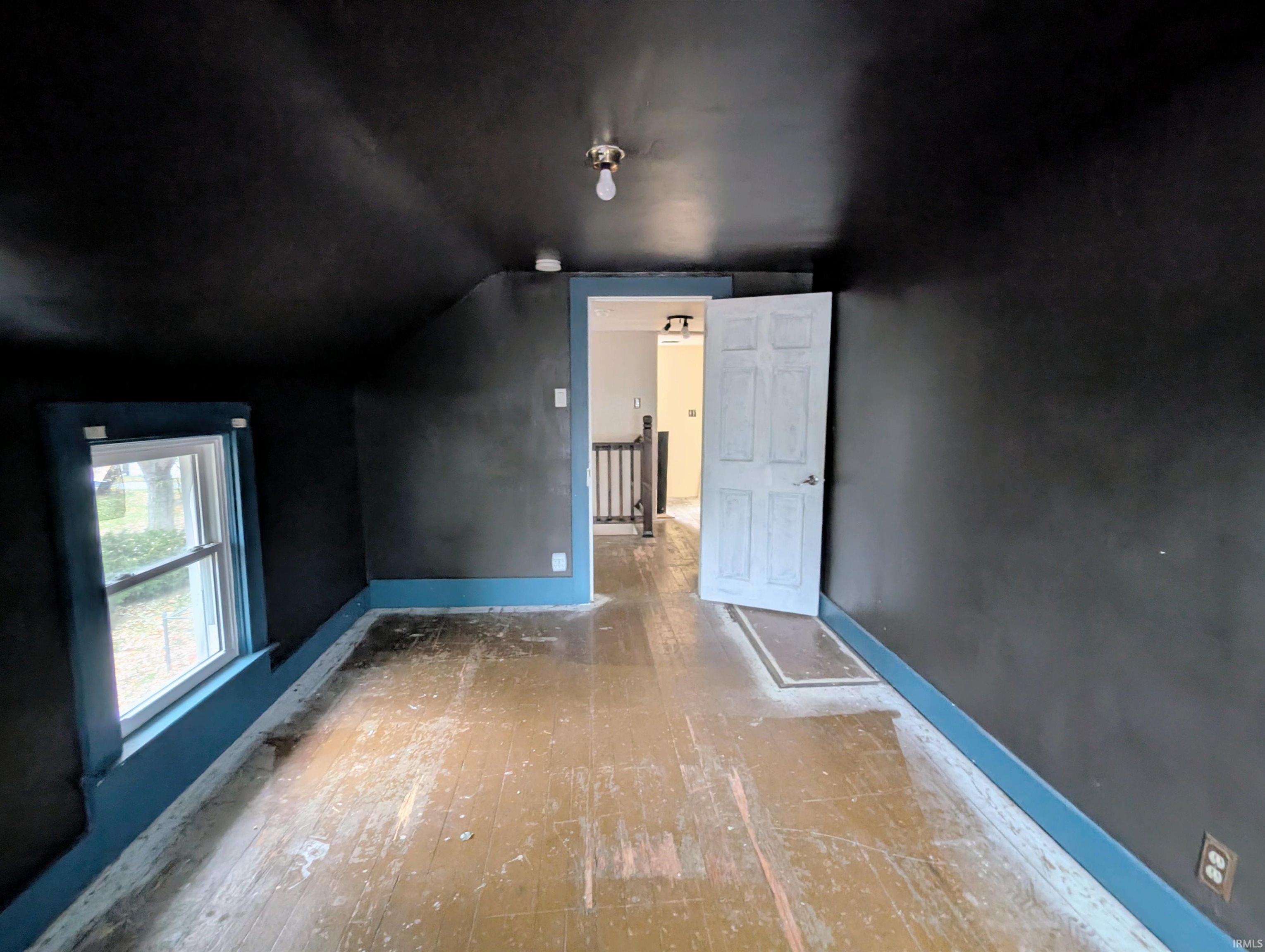 Additional living space featuring baseboards and lofted ceiling