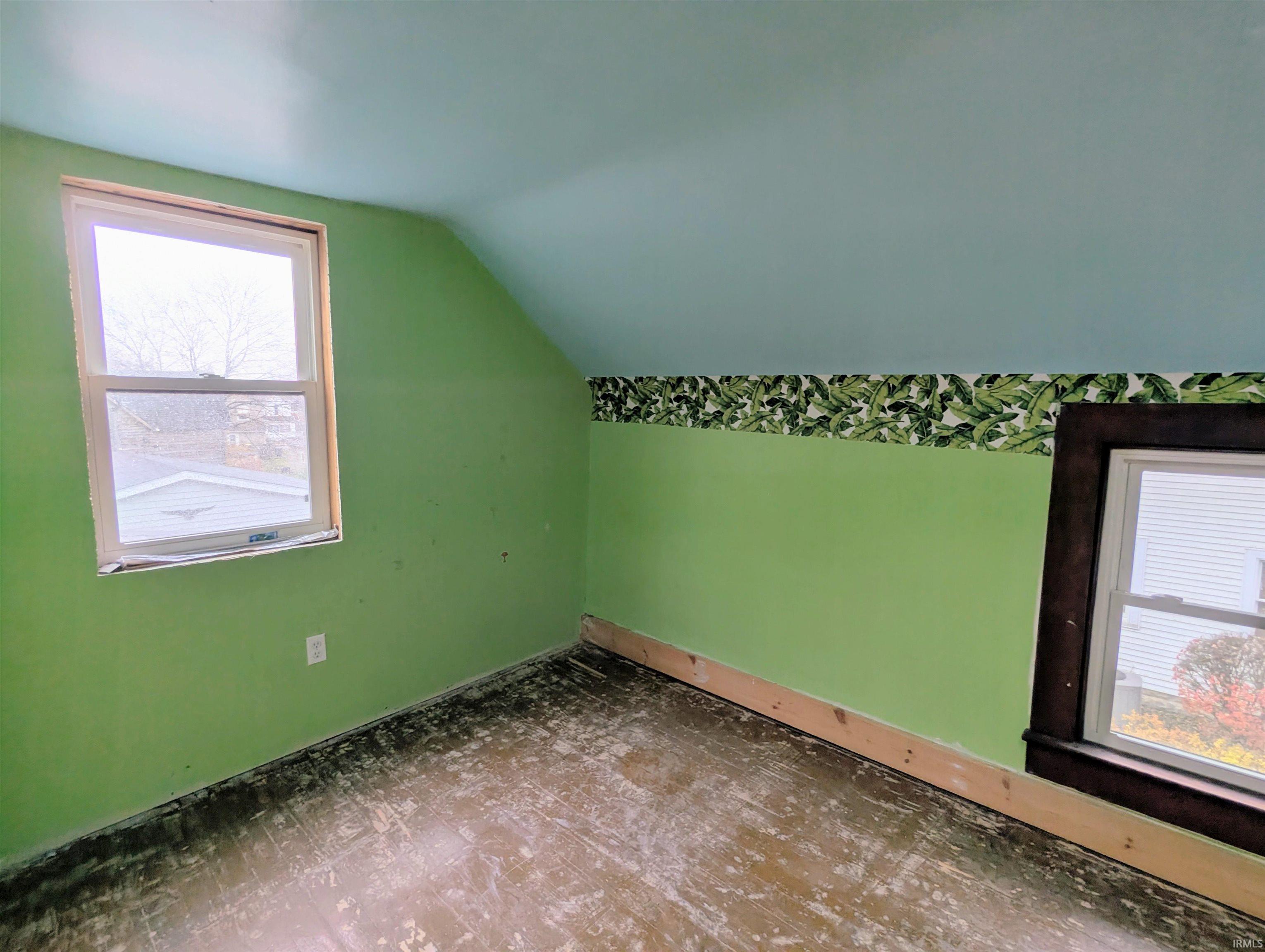 Additional living space featuring lofted ceiling and baseboards