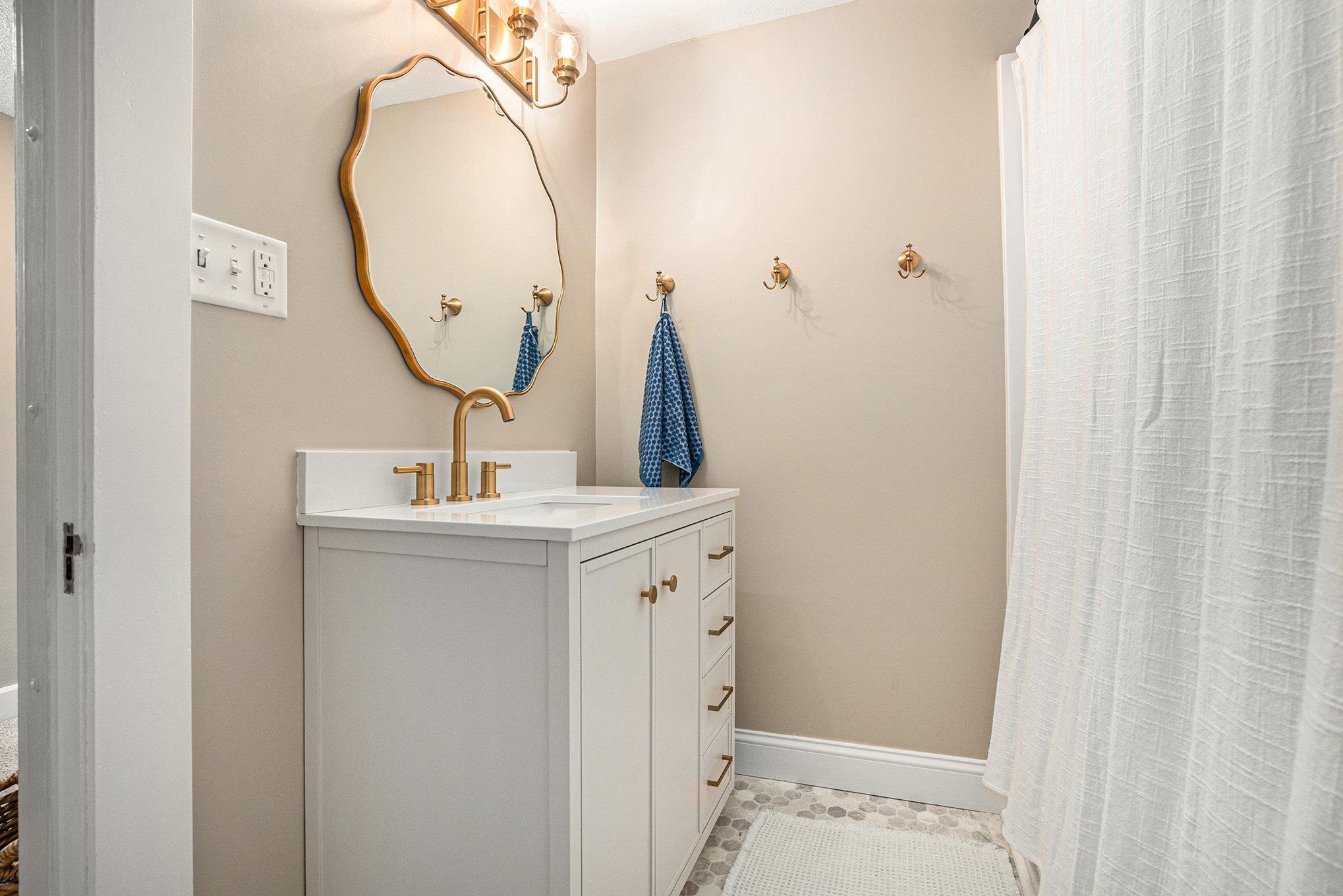 Updated vanity, flooring, mirror, lighting