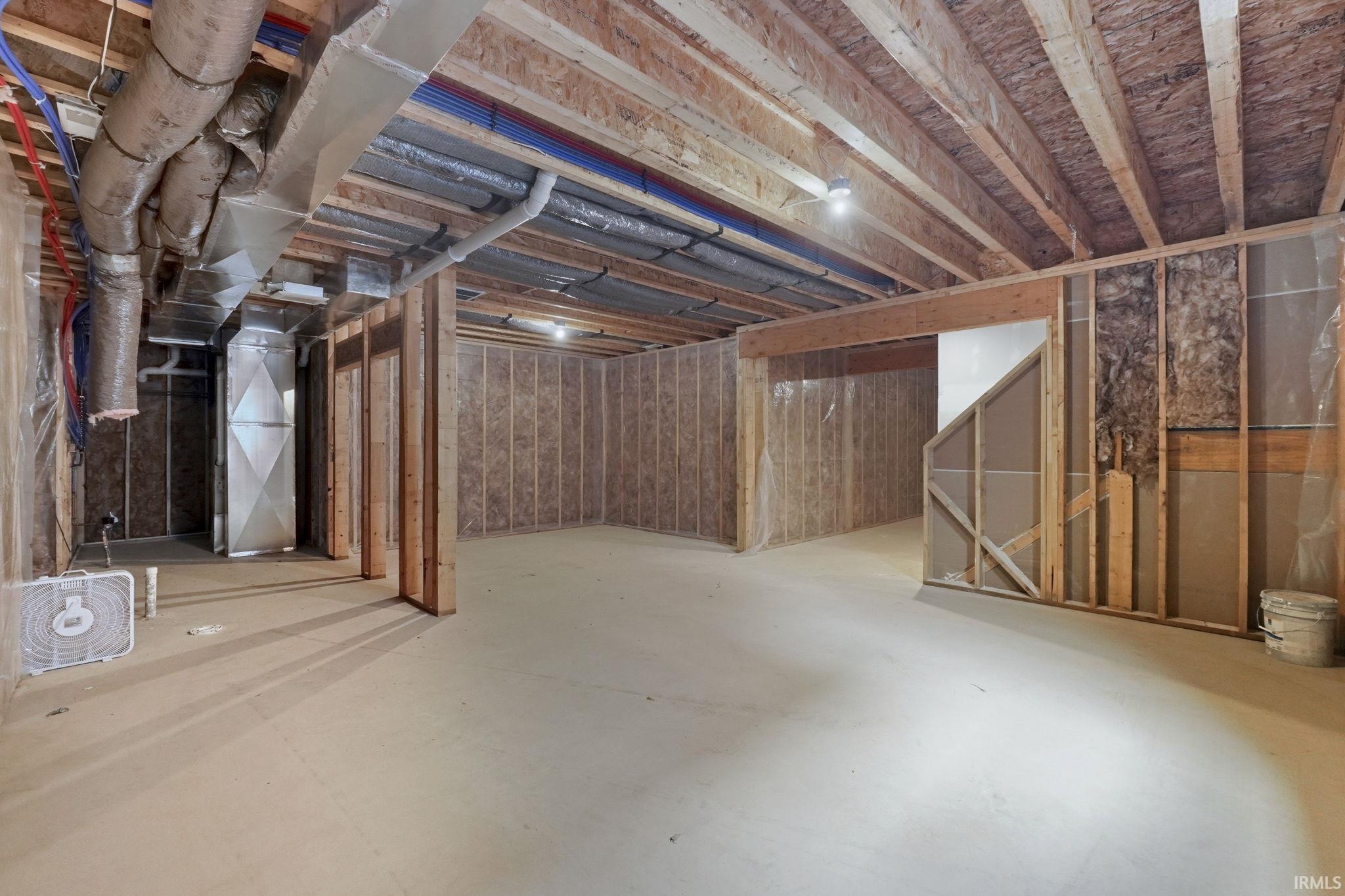 Unfinished below grade area featuring heating unit