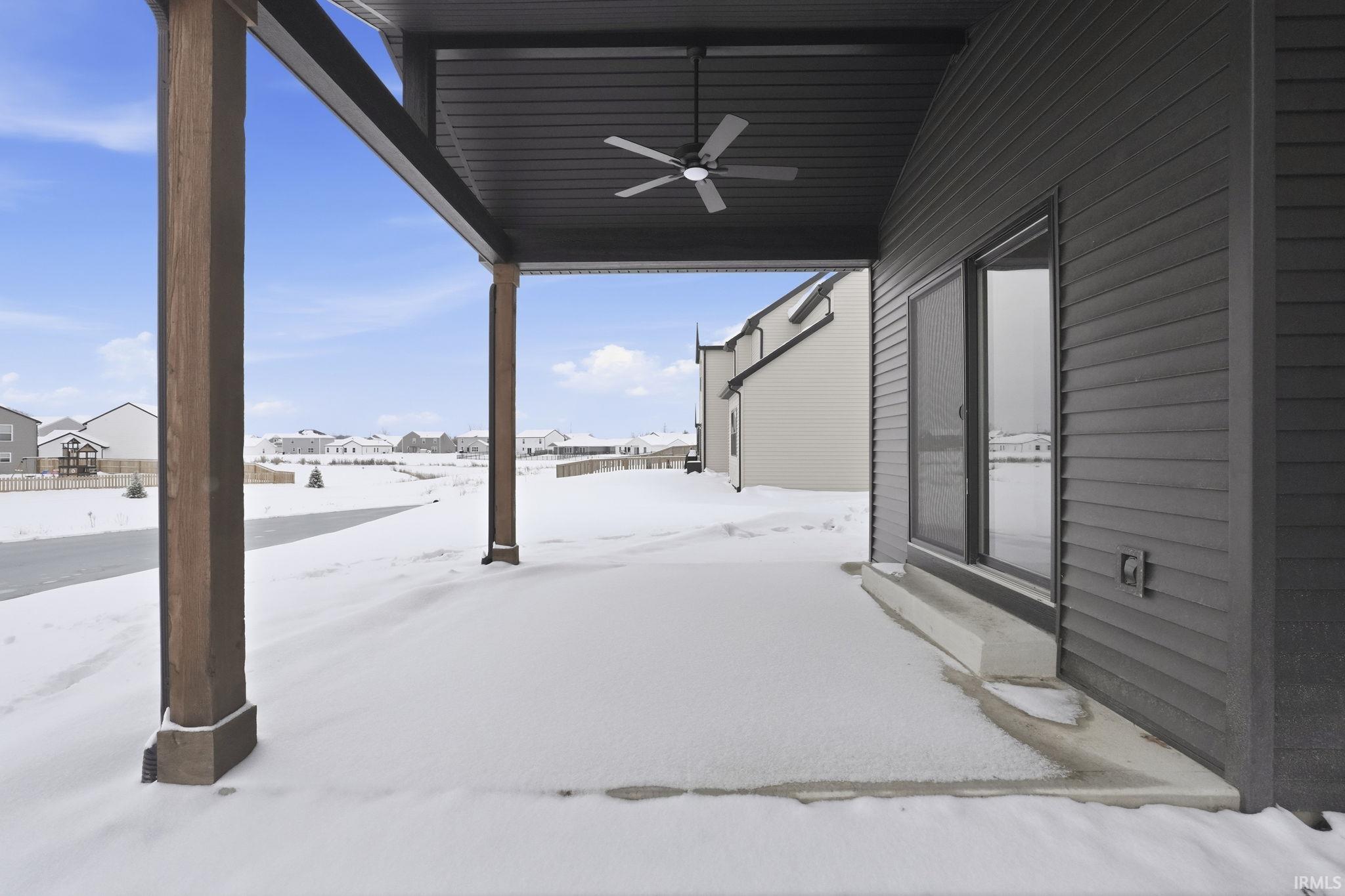 Snow covered patio featuring a ceiling fan