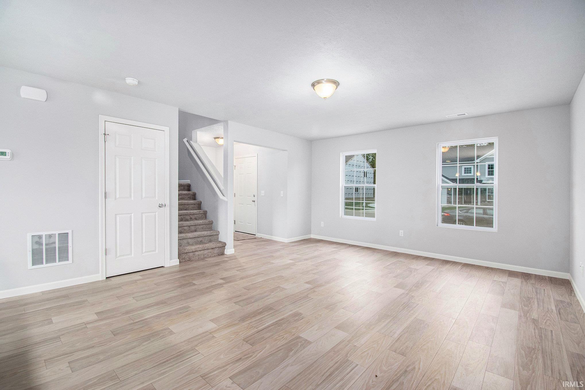 There is an abundance of natural light in the great room.  The stairs to the second floor are discreetly located, maximizing the living space.