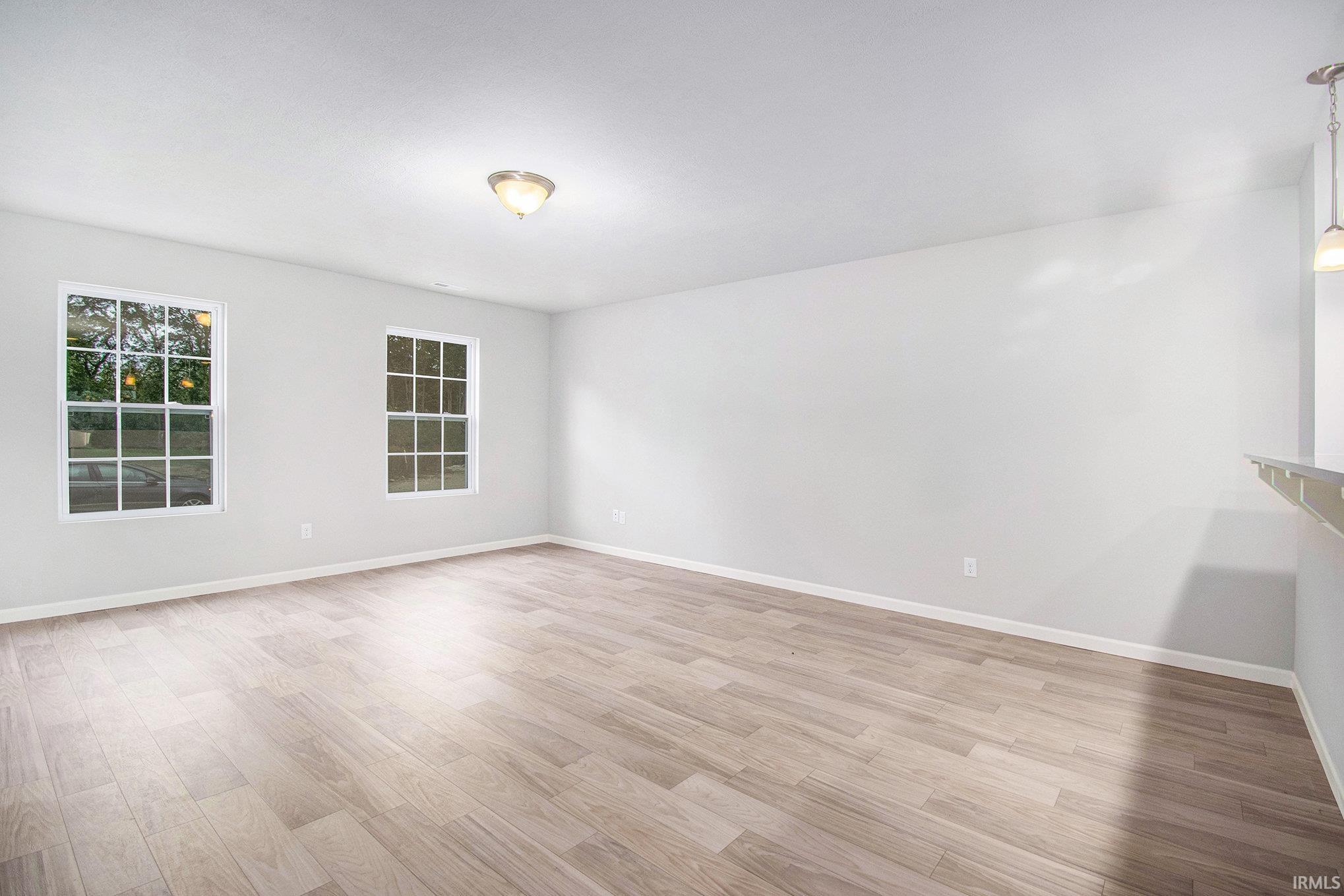 There is an abundance of natural light in the great room.  The stairs to the second floor are discreetly located, maximizing the living space.