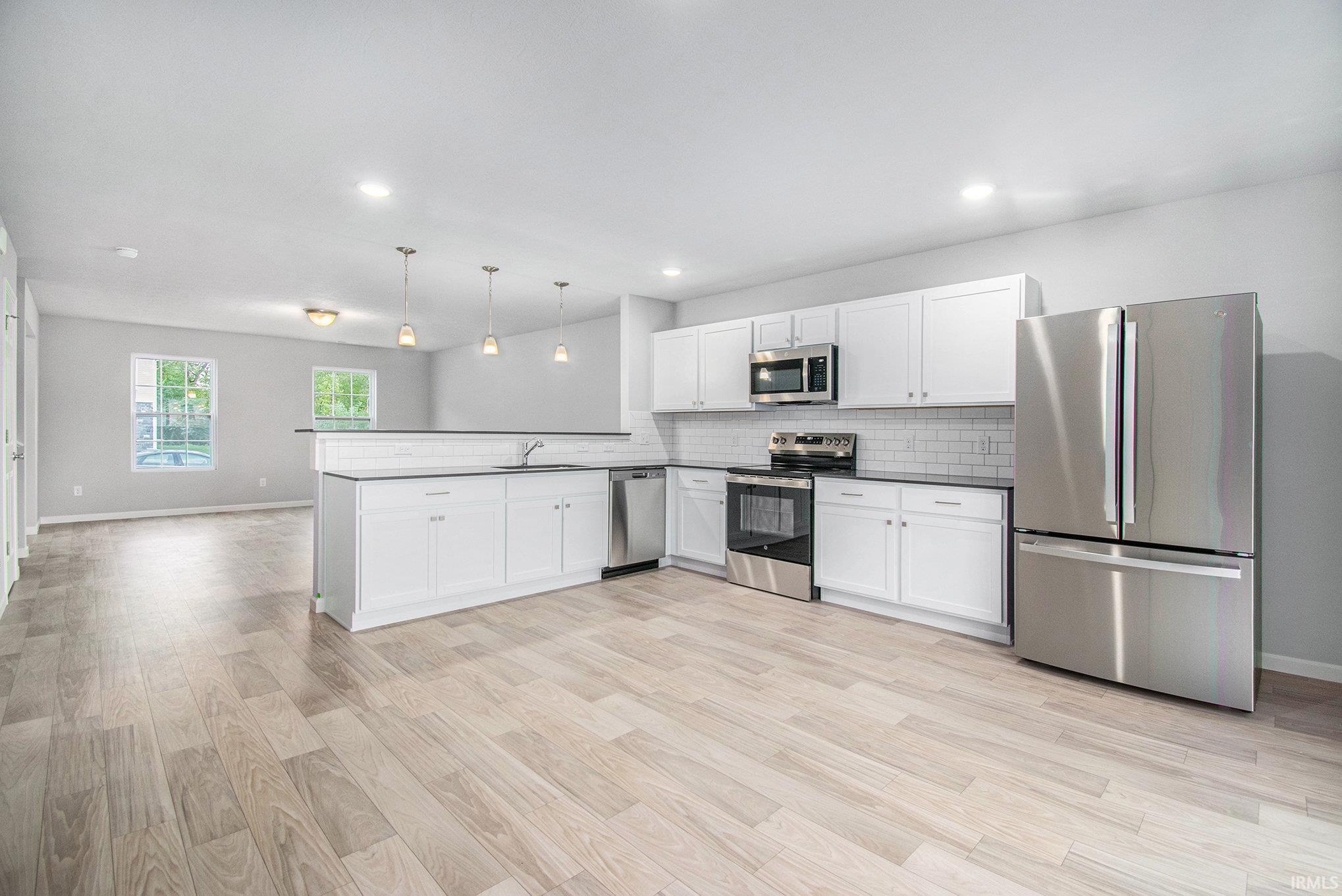 The kitchen and eat-in dining nook are an efficient use of space.  The kitchen has quartz counters accented by subway tile backsplash and offers access to the rear yard.  All appliances are included!
