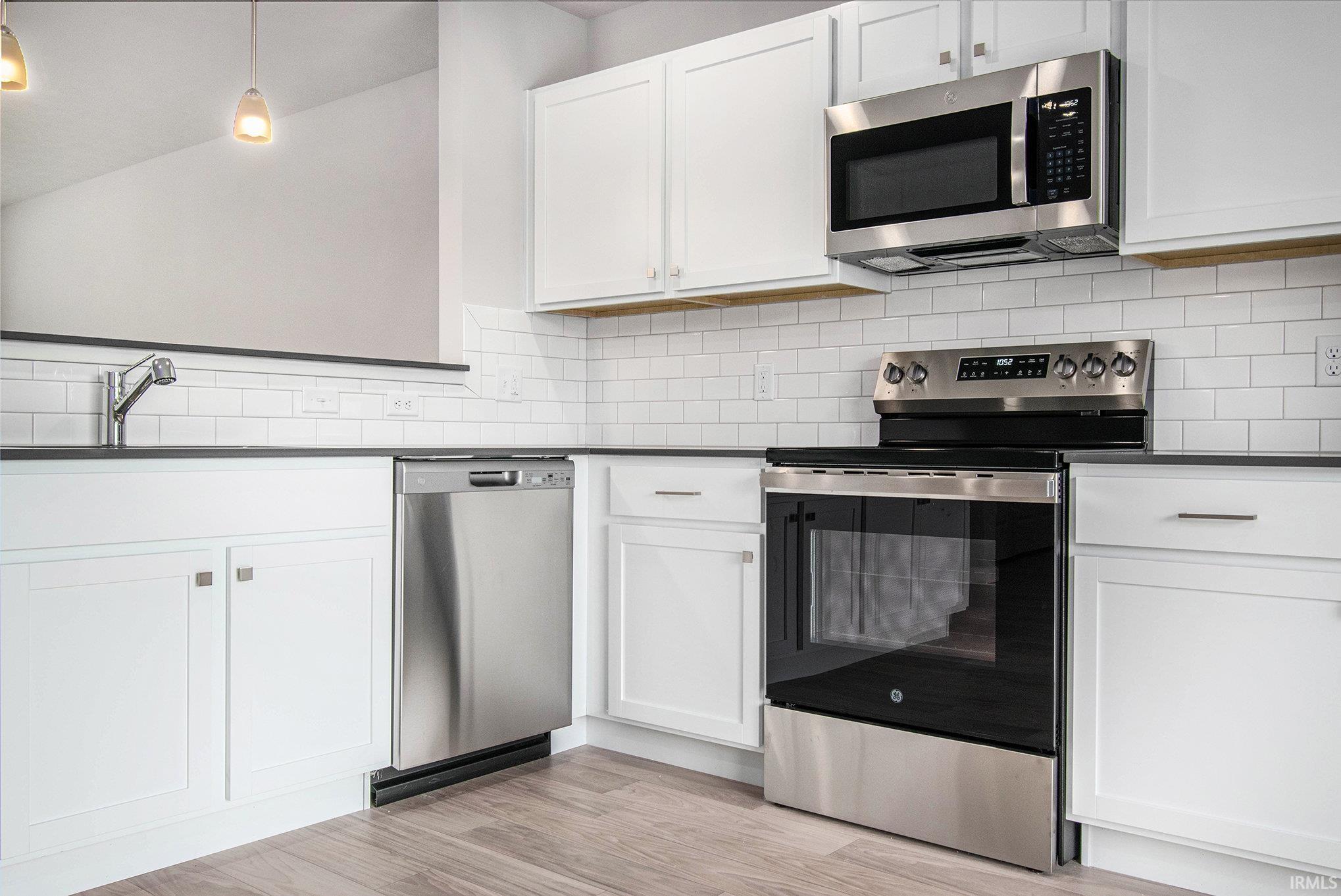 The kitchen and eat-in dining nook are an efficient use of space.  The kitchen has quartz counters accented by subway tile backsplash and offers access to the rear yard.  All appliances are included!