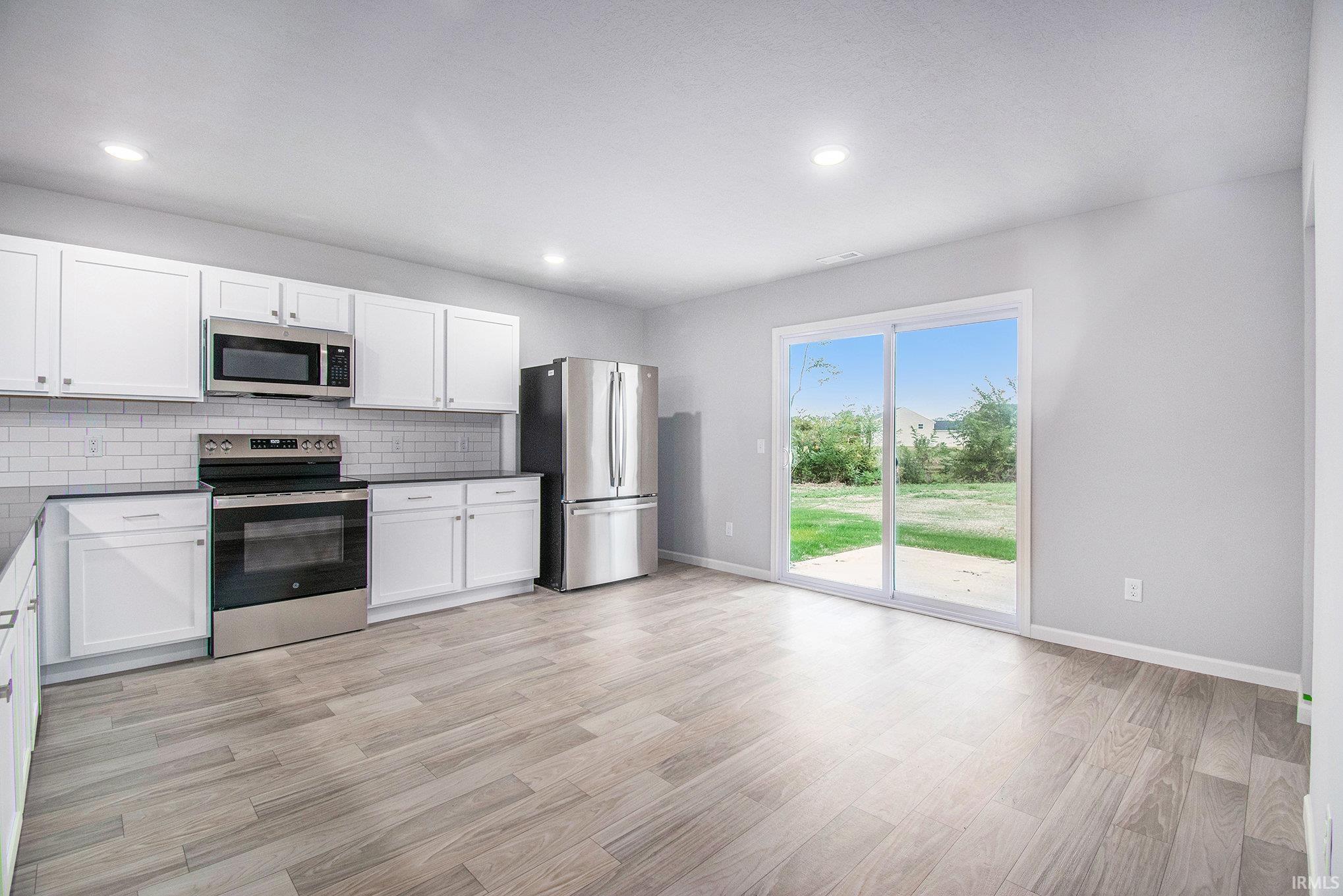 The dining nook can accommodate a large table and has direct access to the rear yard.