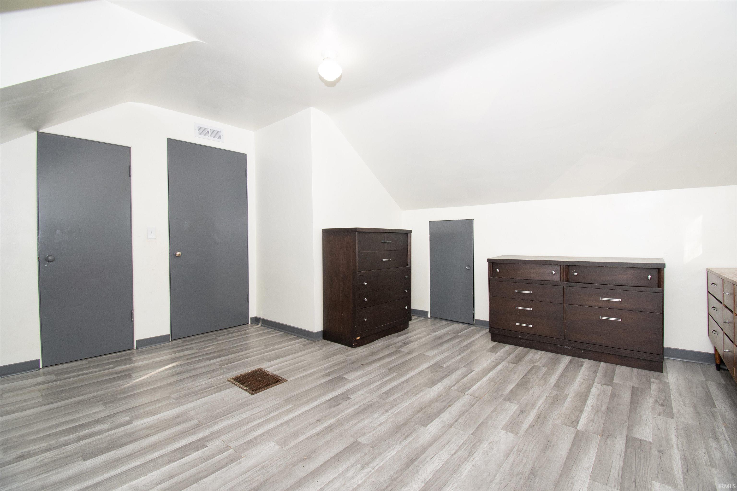 Bonus room featuring lofted ceiling and light wood finished floors