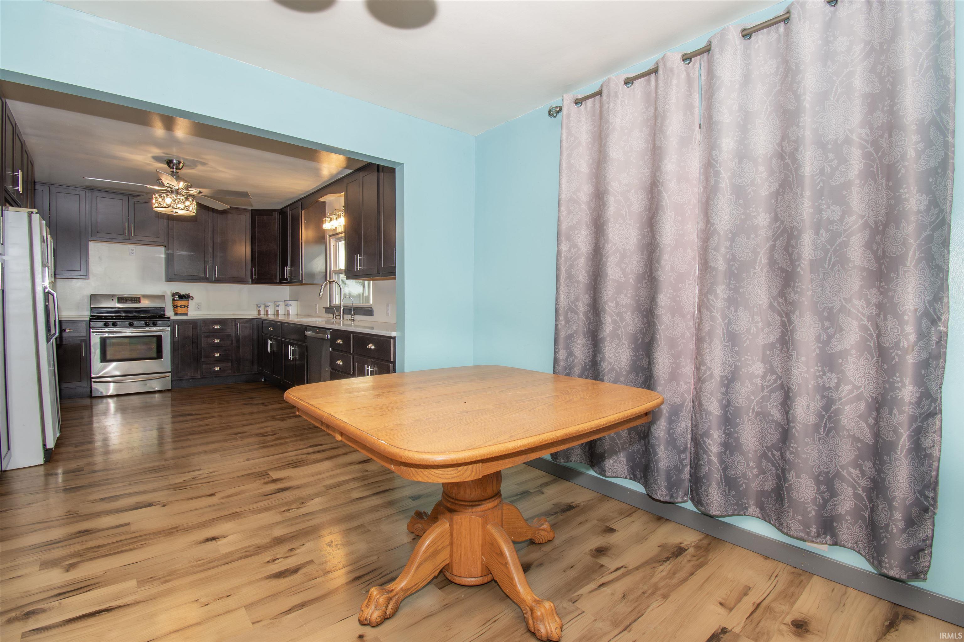 Dining area with light wood-type flooring and a ceiling fan