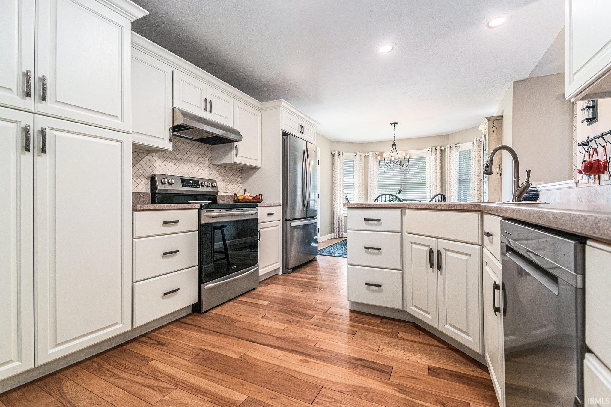 Bright and Cheery Eat-in Kitchen Completely Updated in 2023 with all New Cabinets w/Pull-Outs, Countertops, Hardwood Flooring and Appliances