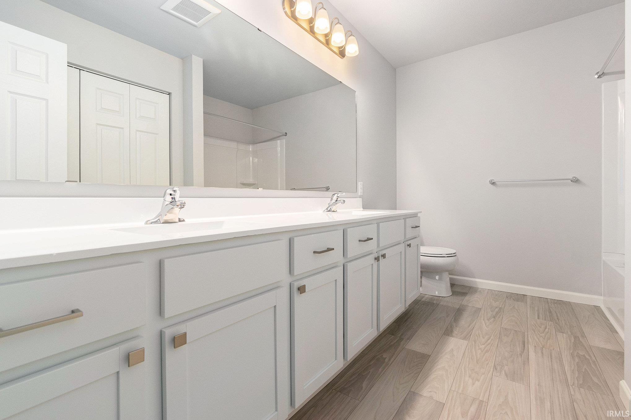 The primary bath features a 60 in vanity and tub/shower combo